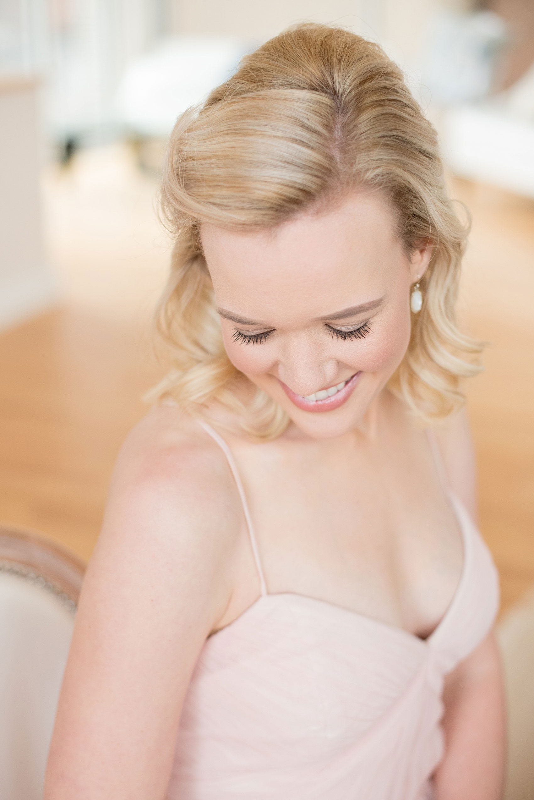 The Glass Box Raleigh wedding photos by Mikkel Paige Photography. Picture of the bridesmaid in a pink Hayley Paige occasion gown with white Kendra Scott drop earrings.