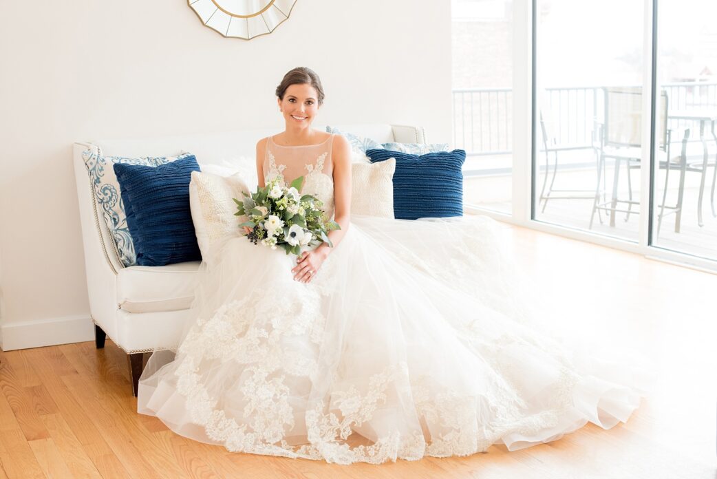 The Glass Box Raleigh wedding photos by Mikkel Paige Photography. Picture of the bride in a Lazaro gown in this modern downtown venue holding a bouquet of eucalyptus and anemones.