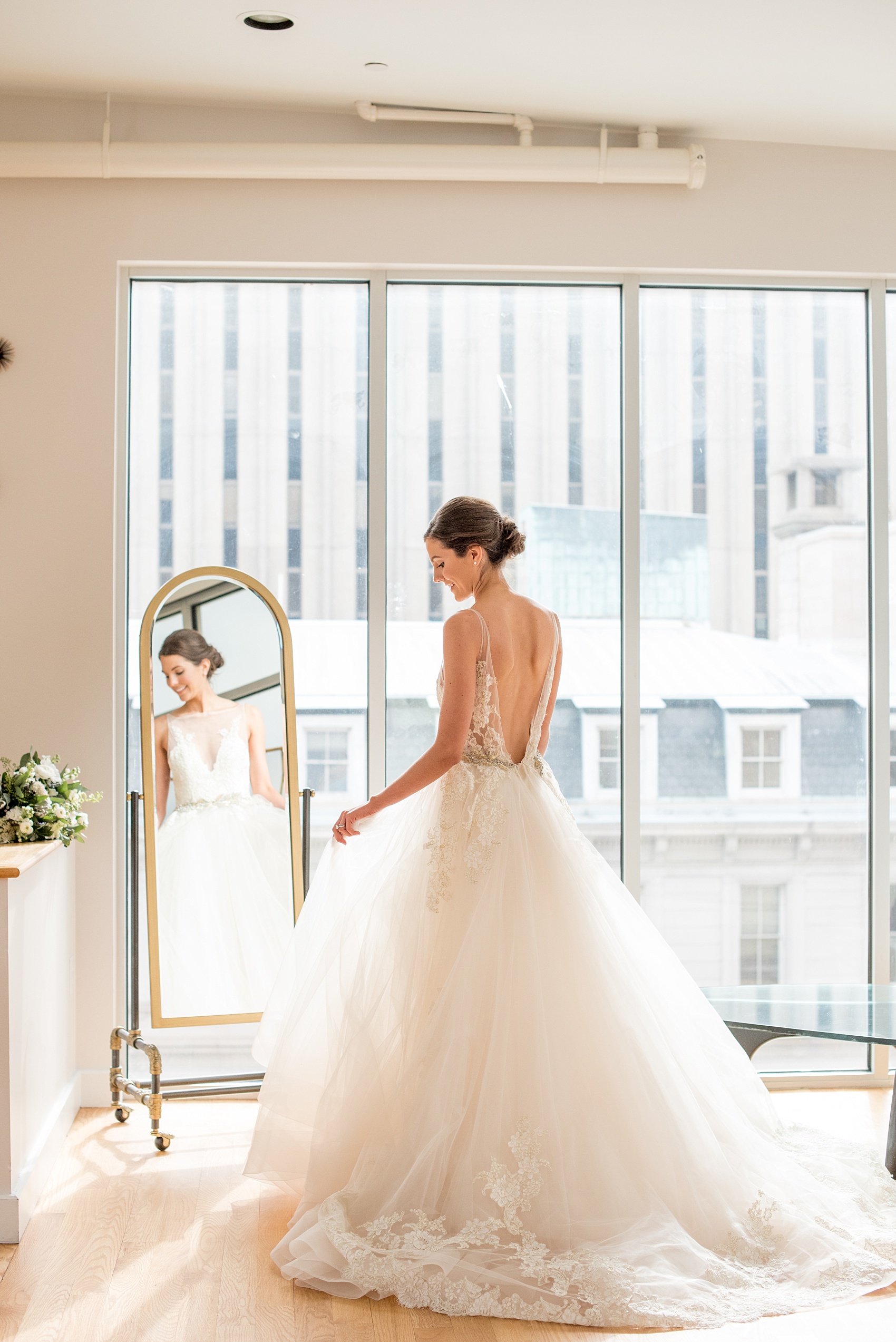 The Glass Box Raleigh wedding photos by Mikkel Paige Photography. Picture of the bride in a Lazaro gown in this modern downtown venue.