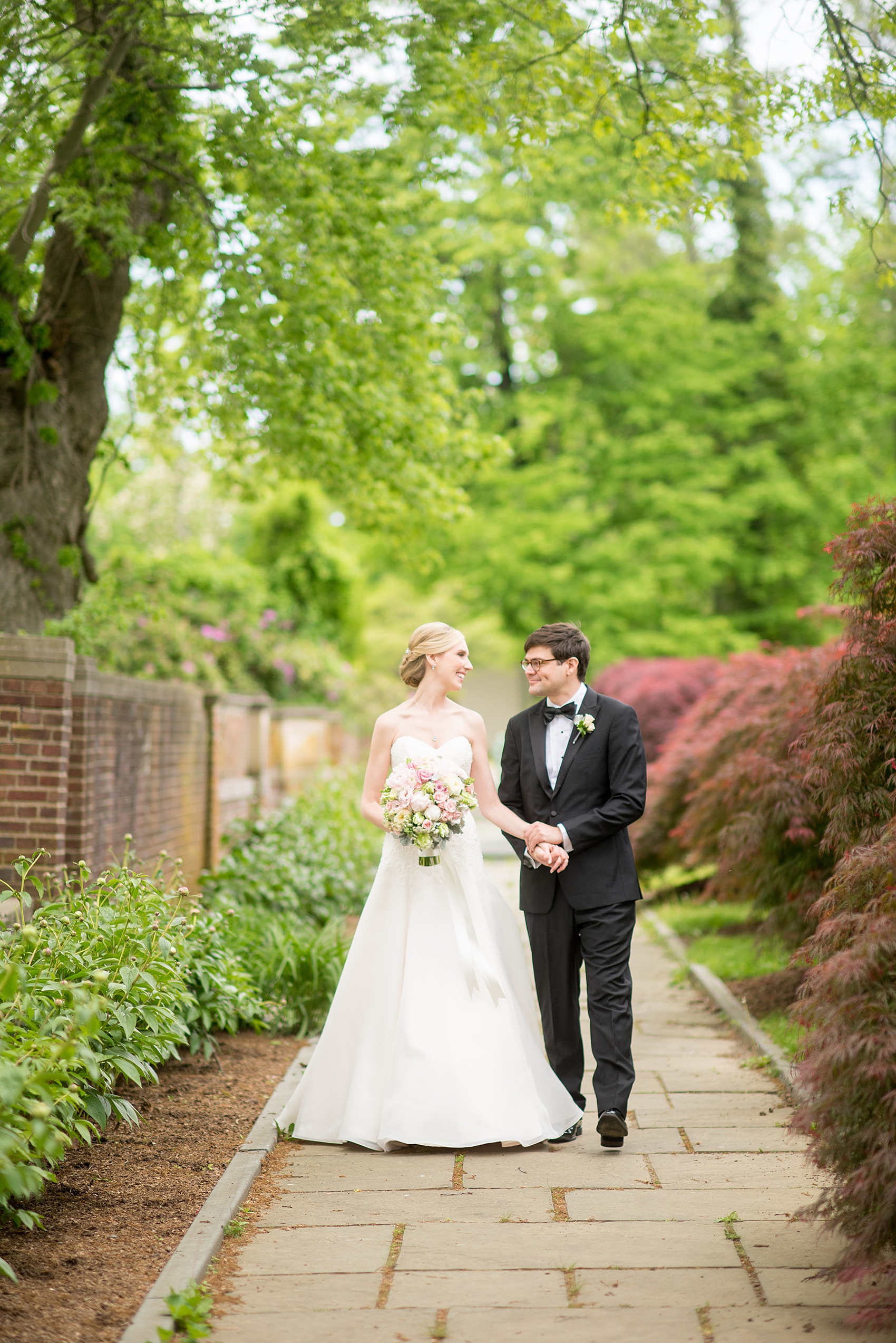 Waveny House wedding photos in Connecticut by Mikkel Paige Photography. Picture of the bride and groom walking in spring flowers. 