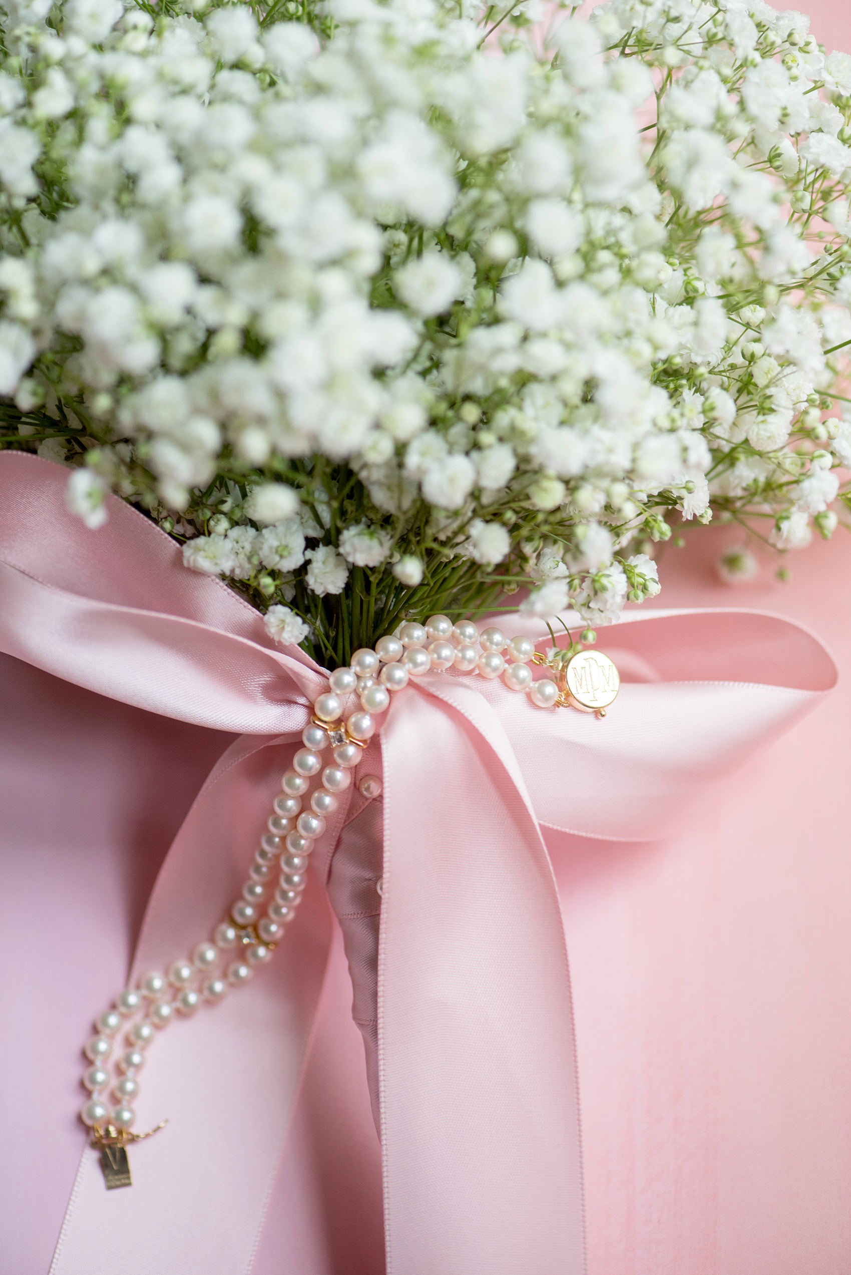 Waveny House wedding photos in Connecticut by Mikkel Paige Photography. Detail picture of the bride's heirloom pearl bracelet with her mother's initials on it. 