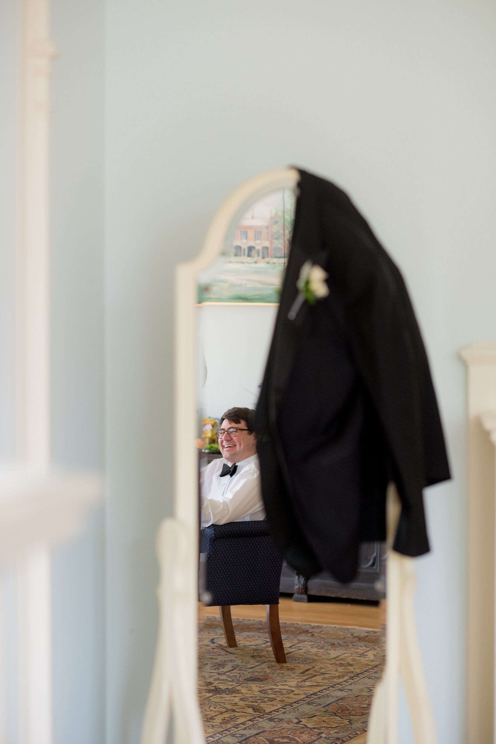 Waveny House wedding photos in Connecticut by Mikkel Paige Photography. Picture of the groom getting ready as seen in the mirror reflection.
