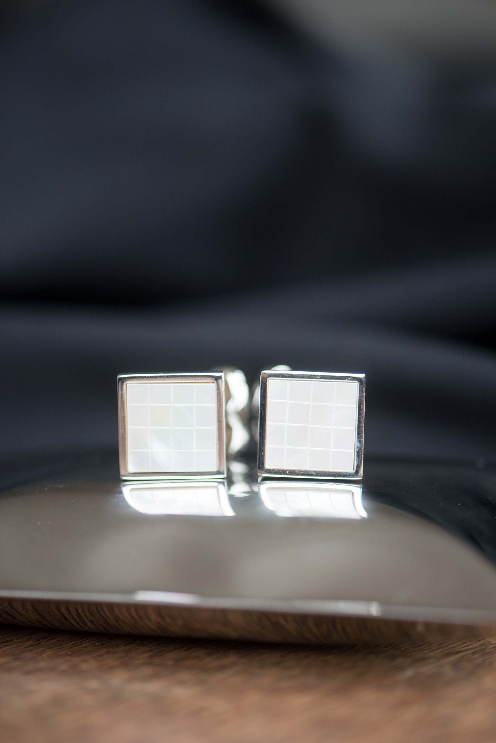 Waveny House wedding photos in Connecticut by Mikkel Paige Photography. Detail picture of the groom's white square mother-of-pearl cufflinks. 