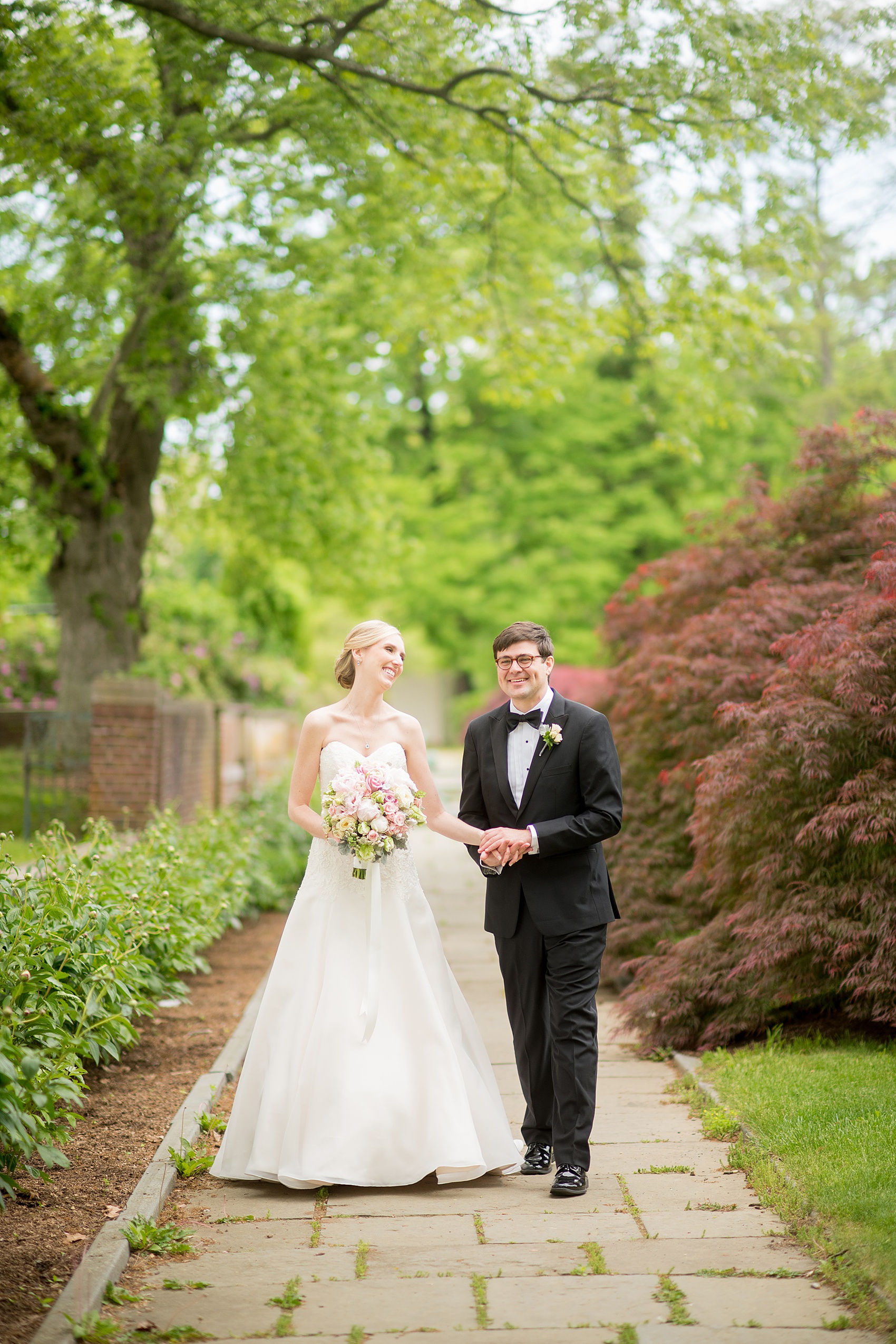 Waveny House wedding photos in Connecticut by Mikkel Paige Photography. Picture of the bride and groom walking in the park.