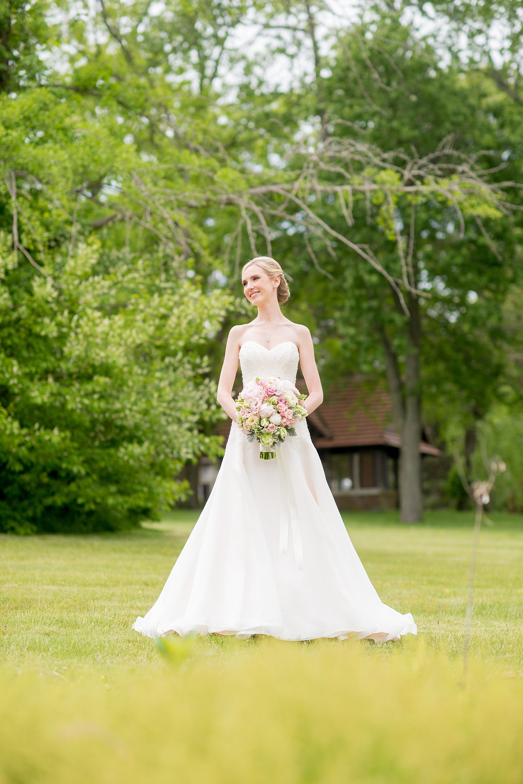 Waveny House wedding photos in Connecticut by Mikkel Paige Photography. Picture of the bride in a strapless wedding gown with pink and green bouquet.