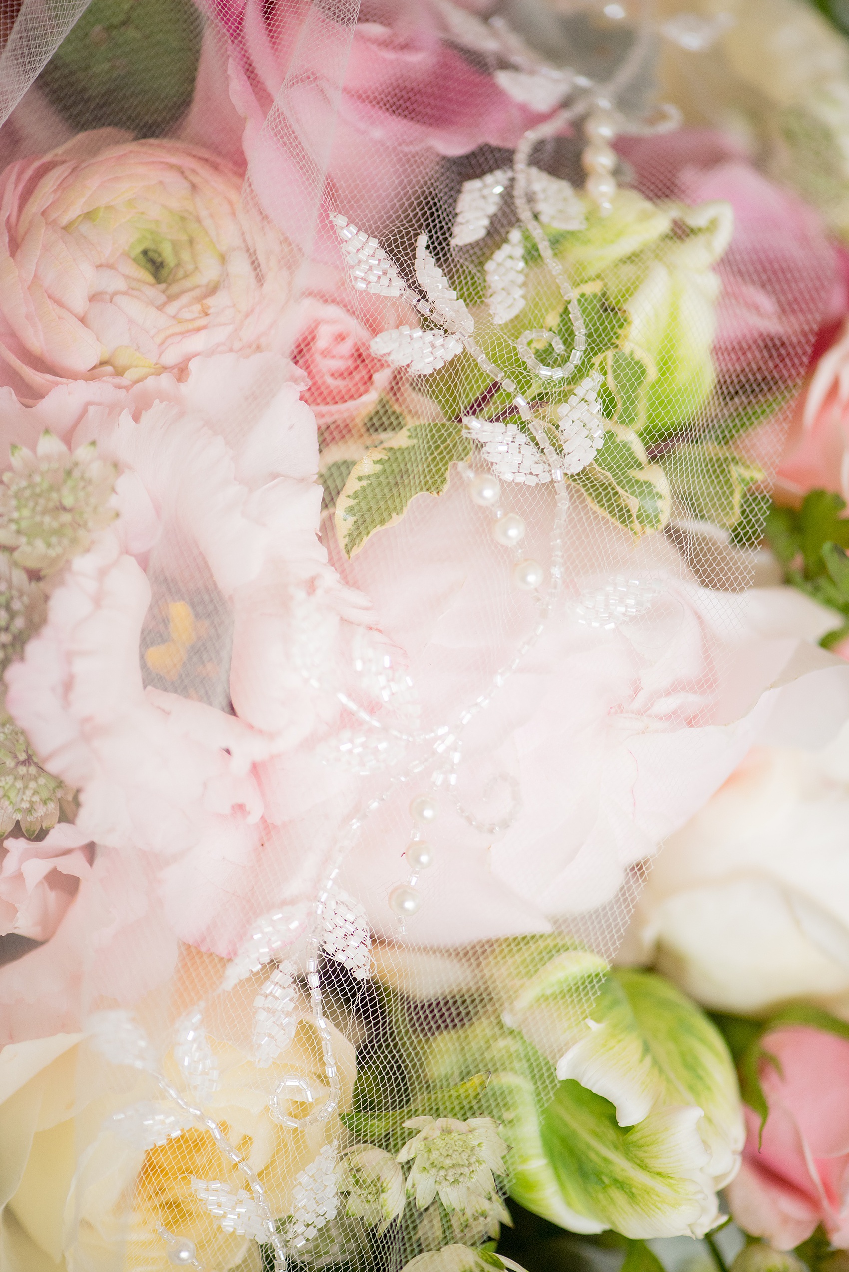 Waveny House wedding photos in Connecticut by Mikkel Paige Photography. Detail picture of the bride's beaded veil on her pink and green bouquet.