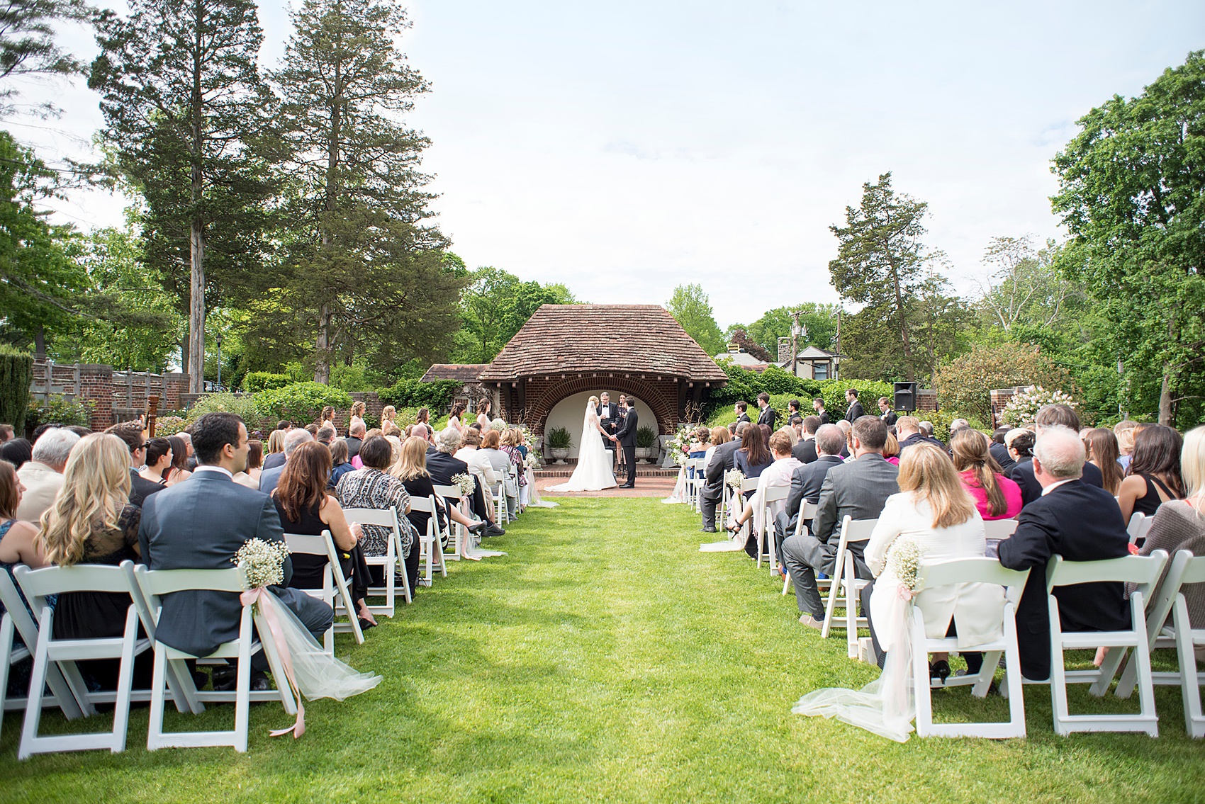Waveny House wedding photos in Connecticut by Mikkel Paige Photography. Picture of a spring outdoor ceremony in a walled garden. 