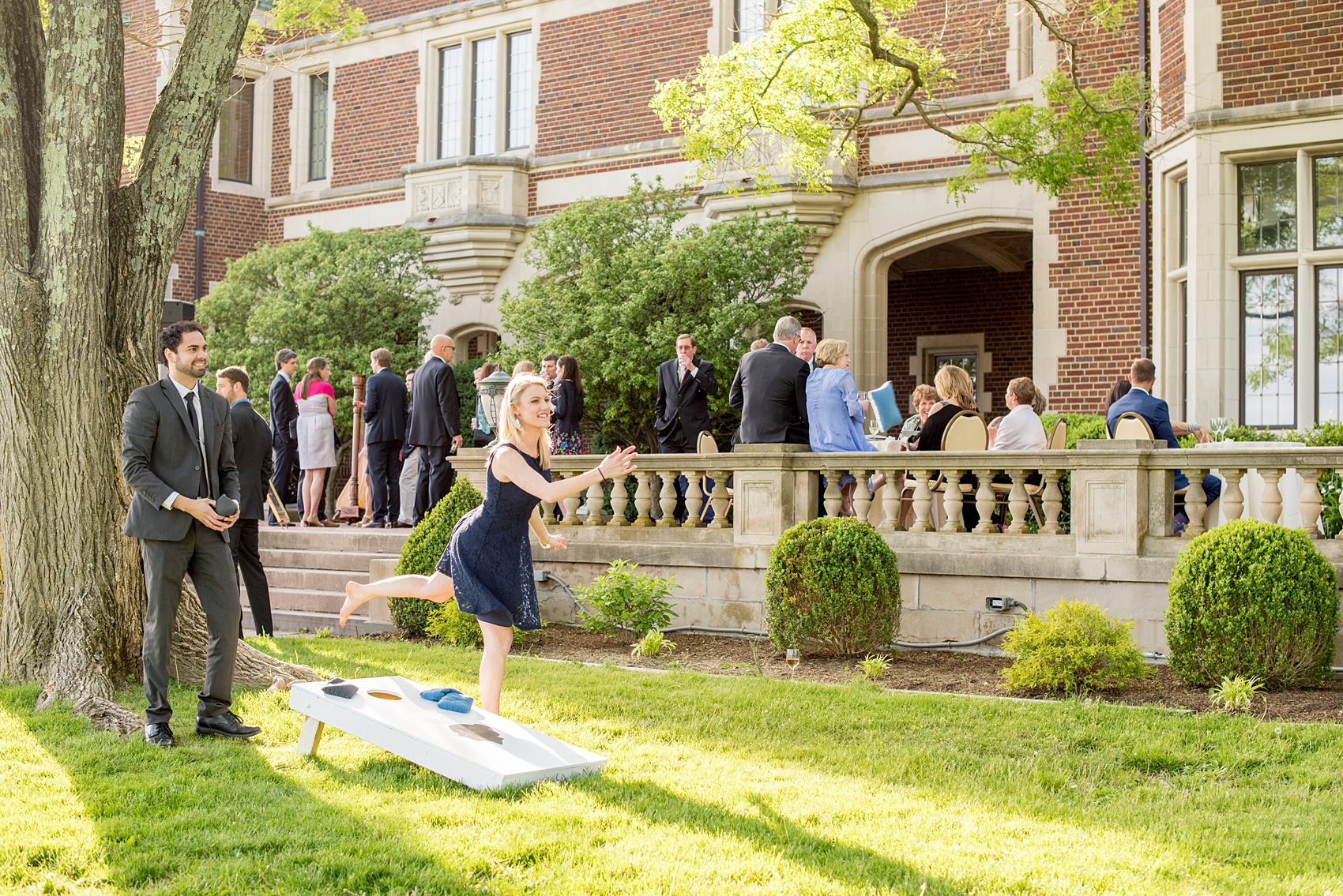 Waveny House wedding photos in Connecticut by Mikkel Paige Photography. Picture of the guests playing cornhole outside during cocktail hour.