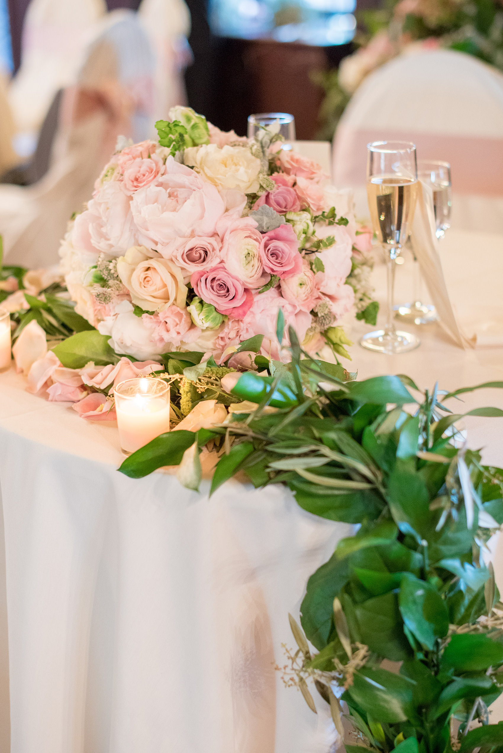 Waveny House wedding photos in Connecticut by Mikkel Paige Photography. Picture of the sweetheart table with greenery garland and the bride's pink and green bouquet.