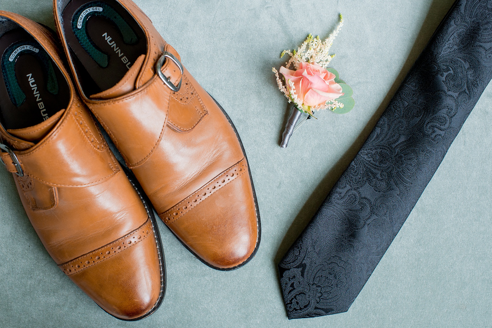 Mikkel Paige Photography photos from a wedding in Durham, North Carolina at King's Daughters Inn. Detail image of the grooms shoes, tie and peach rose boutonniere.