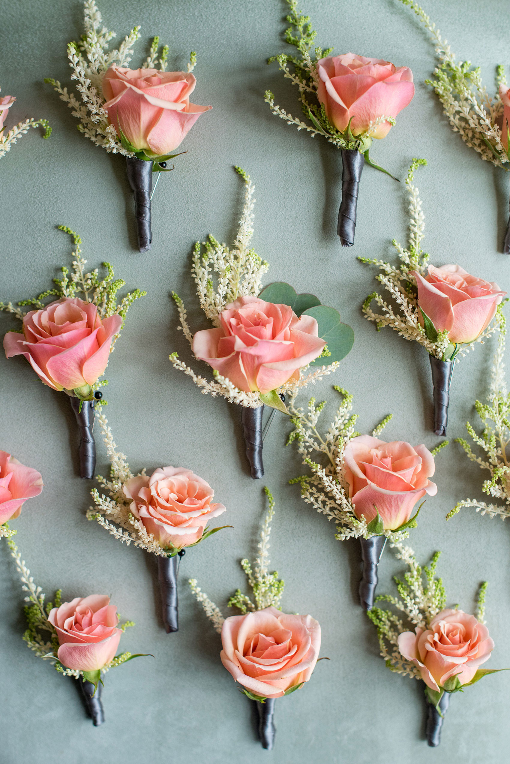 Mikkel Paige Photography photos from a wedding in Durham, North Carolina. Detail image of the peach spray rose boutonnieres by Teacup Floral.