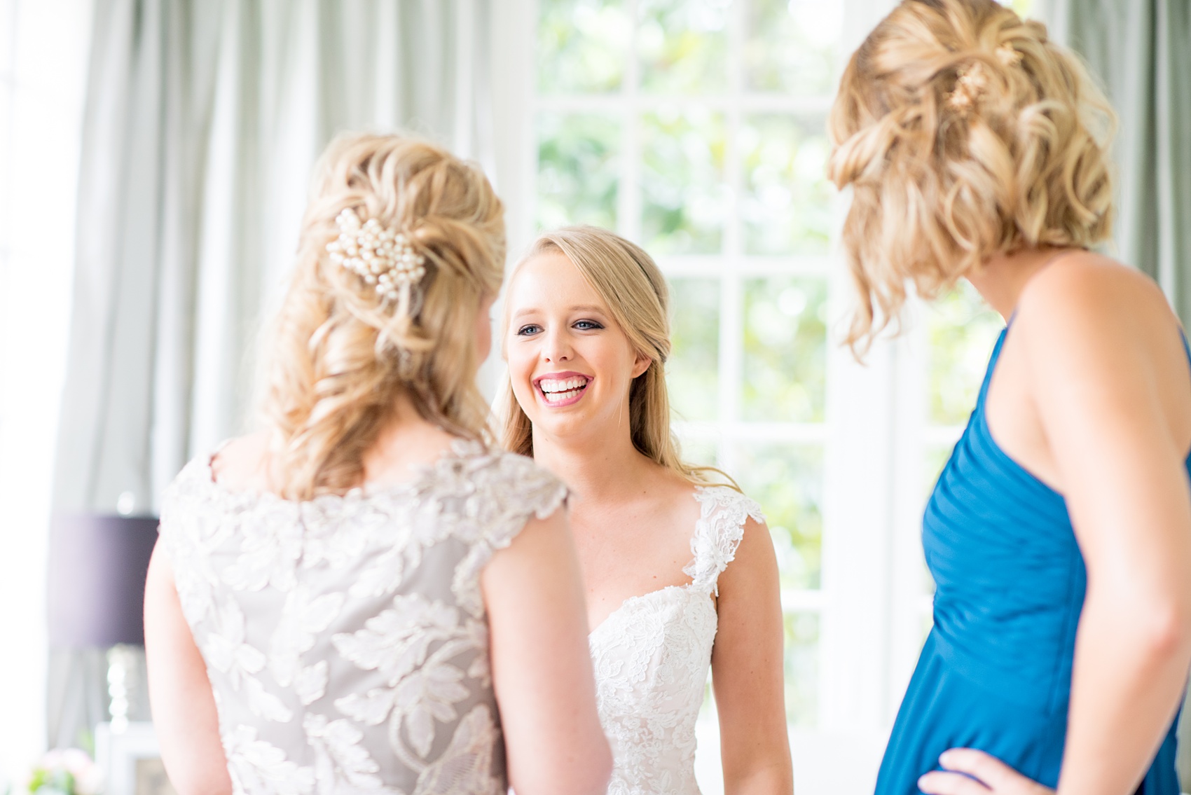 Mikkel Paige Photography photos from getting ready photos in Durham, North Carolina. Picture of the bride getting ready with her mother and sister, Maid of Honor, in a suite in King's Daughters Inn.