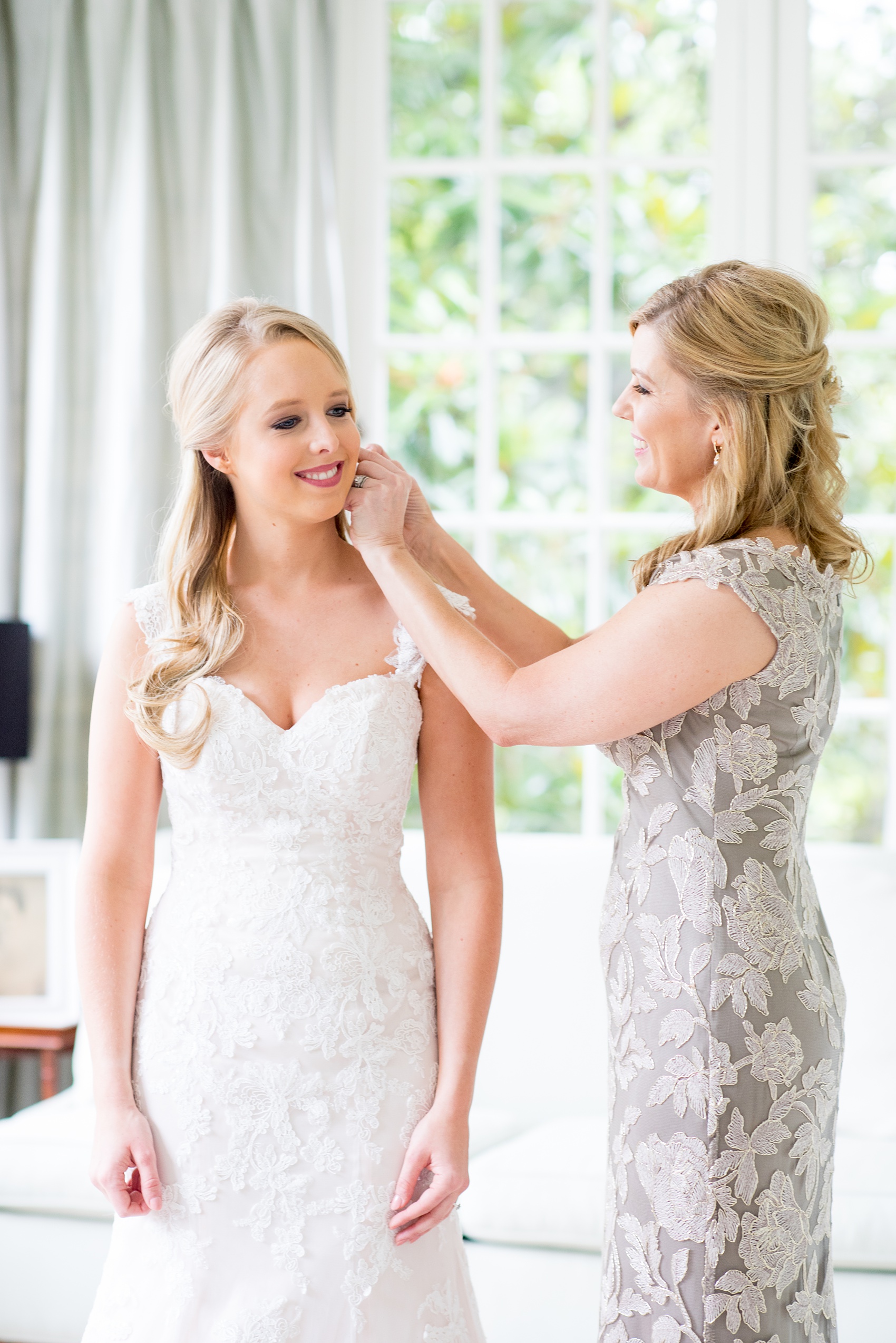 Mikkel Paige Photography photos from getting ready photos in Durham, North Carolina. Picture of the bride getting ready with her mother in a suite in King's Daughters Inn.