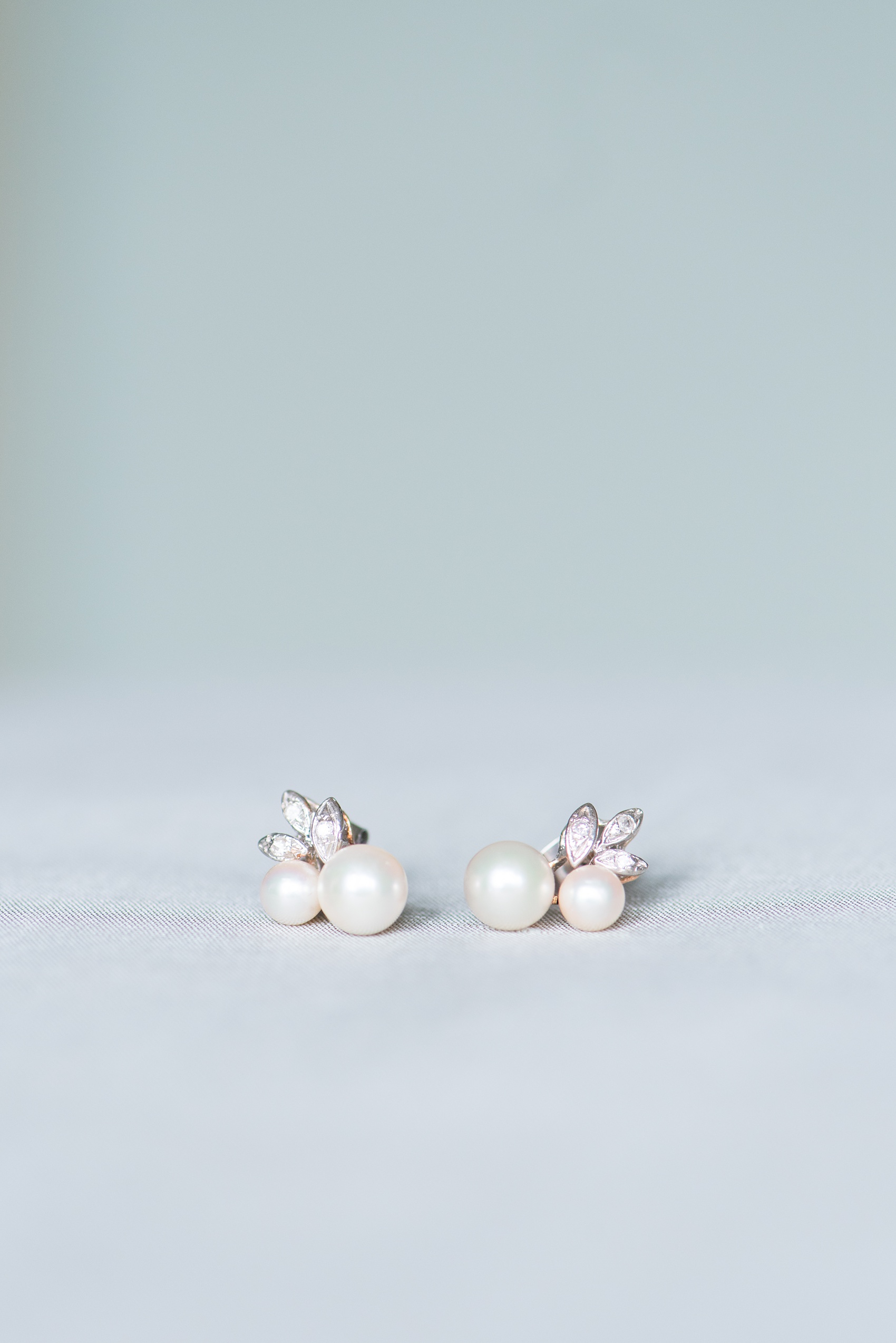 Mikkel Paige Photography photos from getting ready photos in Durham, North Carolina. Detail picture of the bride's family heirloom pearl and diamond earrings her mother wore to her own wedding.