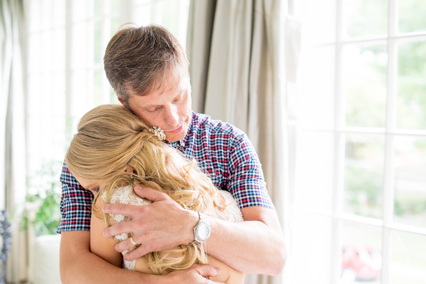 Mikkel Paige Photography photos from getting ready photos at King's Daughter's Inn, Durham, North Carolina. Picture of the bride hugging her father after their first look.