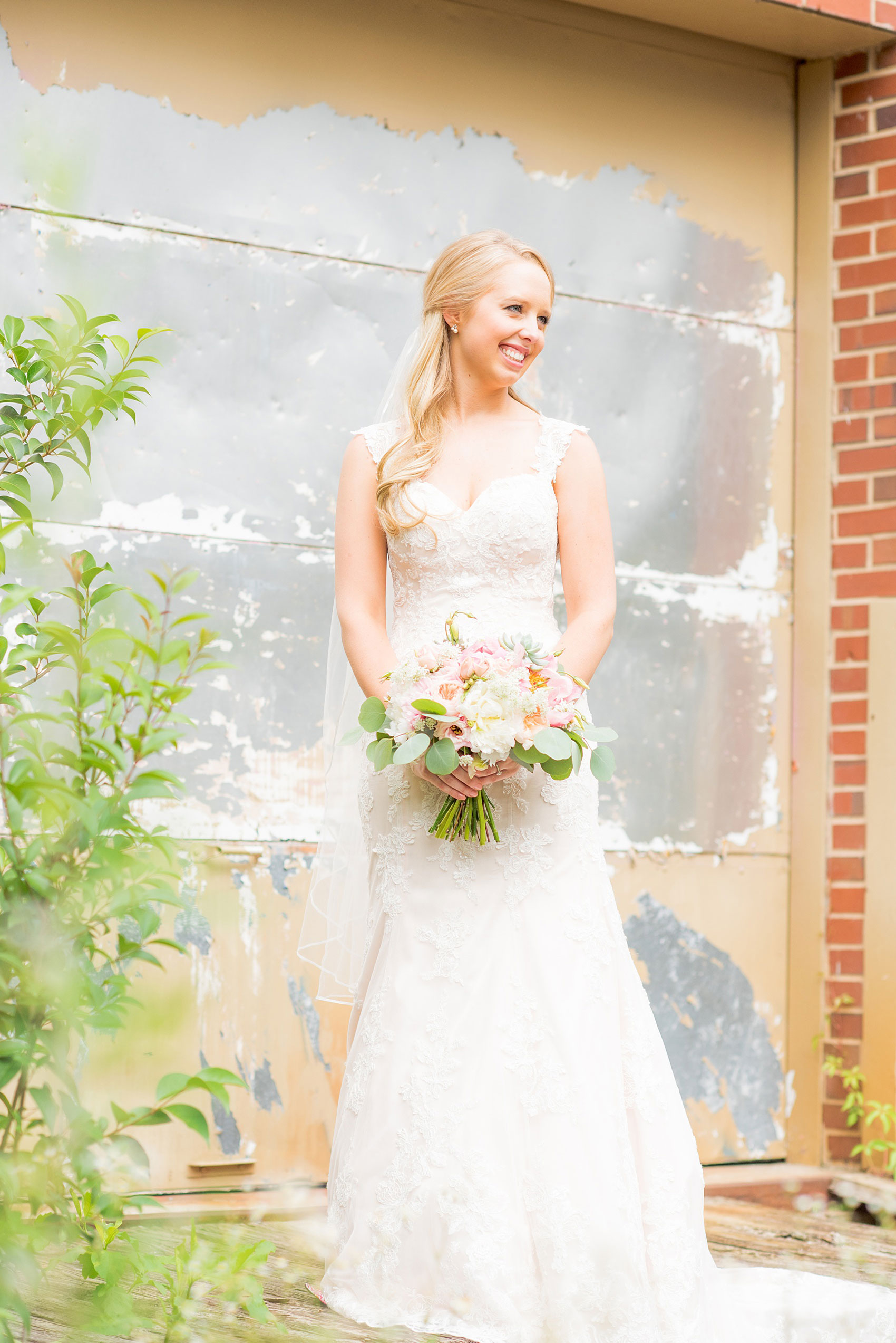 Mikkel Paige Photography photos from a wedding in Durham, North Carolina. Picture of the bride in an urban, rustic setting.