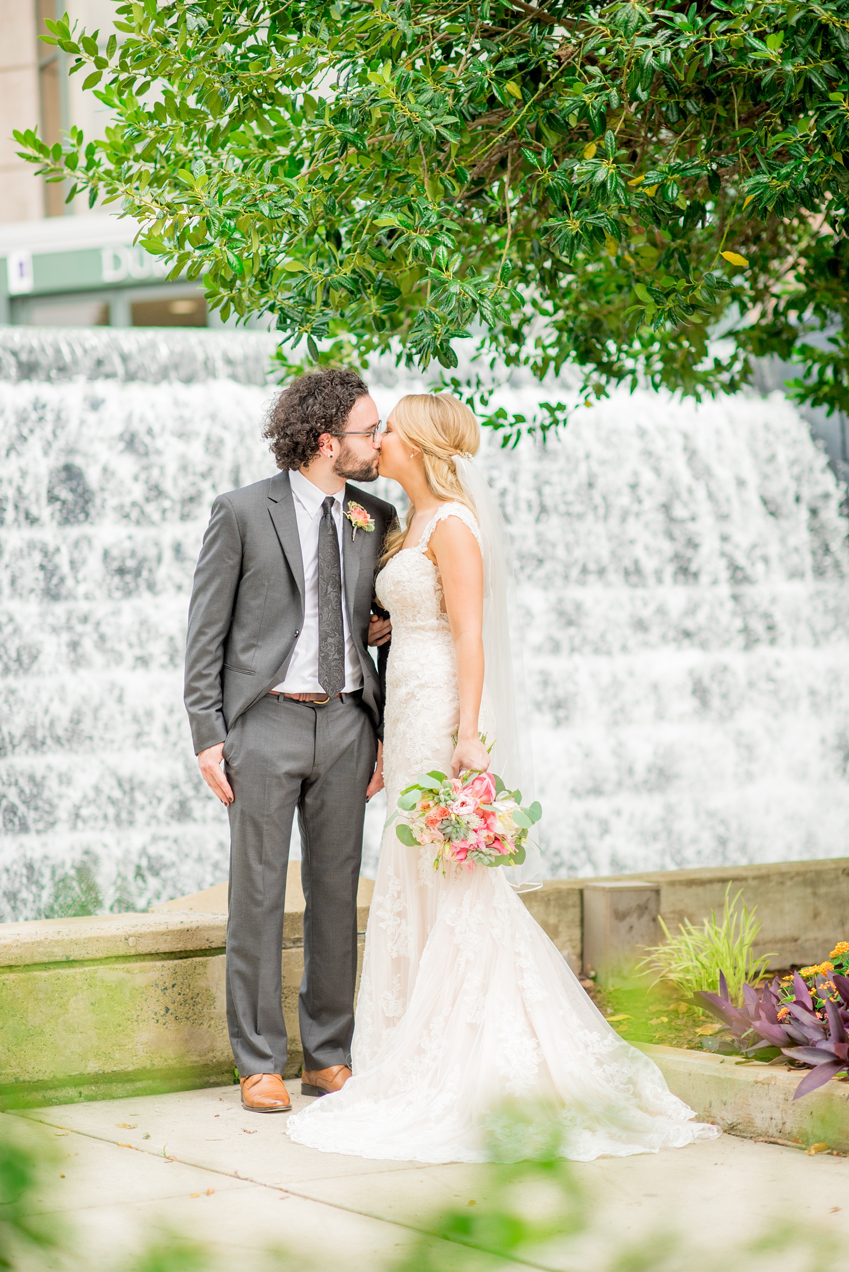 Mikkel Paige Photography photos from a wedding in Durham, North Carolina. Picture of the bride and groom in front of a waterfall downtown.