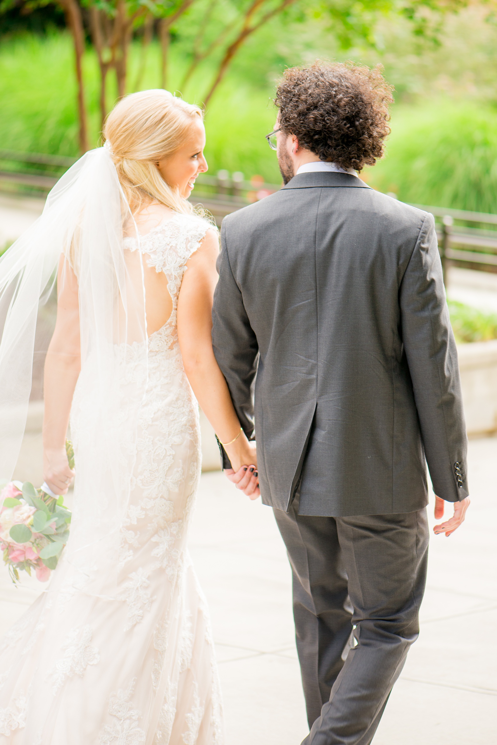 Mikkel Paige Photography photos from a wedding in Durham, North Carolina. Picture of the bride and groom walking downtown.