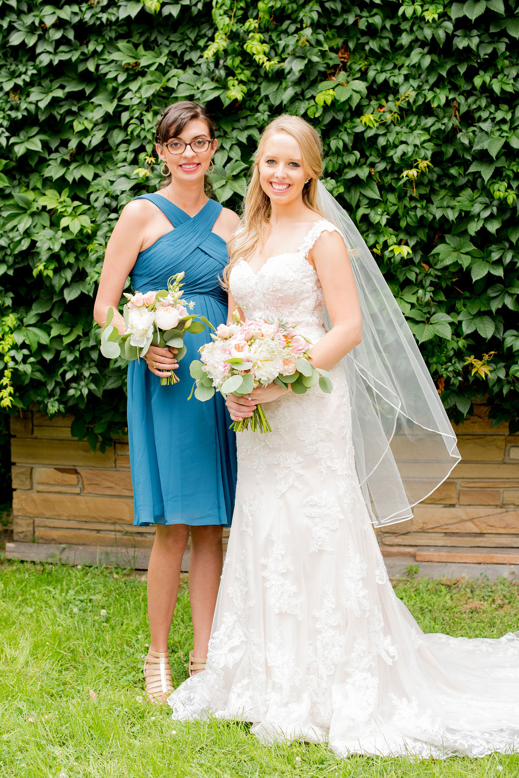 Mikkel Paige Photography photos from a wedding in Durham, North Carolina. Picture of the bride and her maid of honor in a short teal dress and peony and succulent bouquets.
