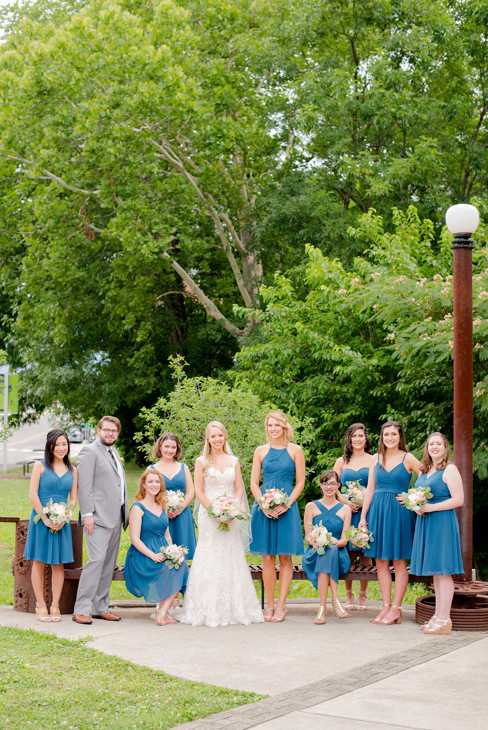 Mikkel Paige Photography photos from a wedding in Durham, North Carolina. Vogue like picture of the bridesmaids in teal dresses and a bridesdude in a grey suit.