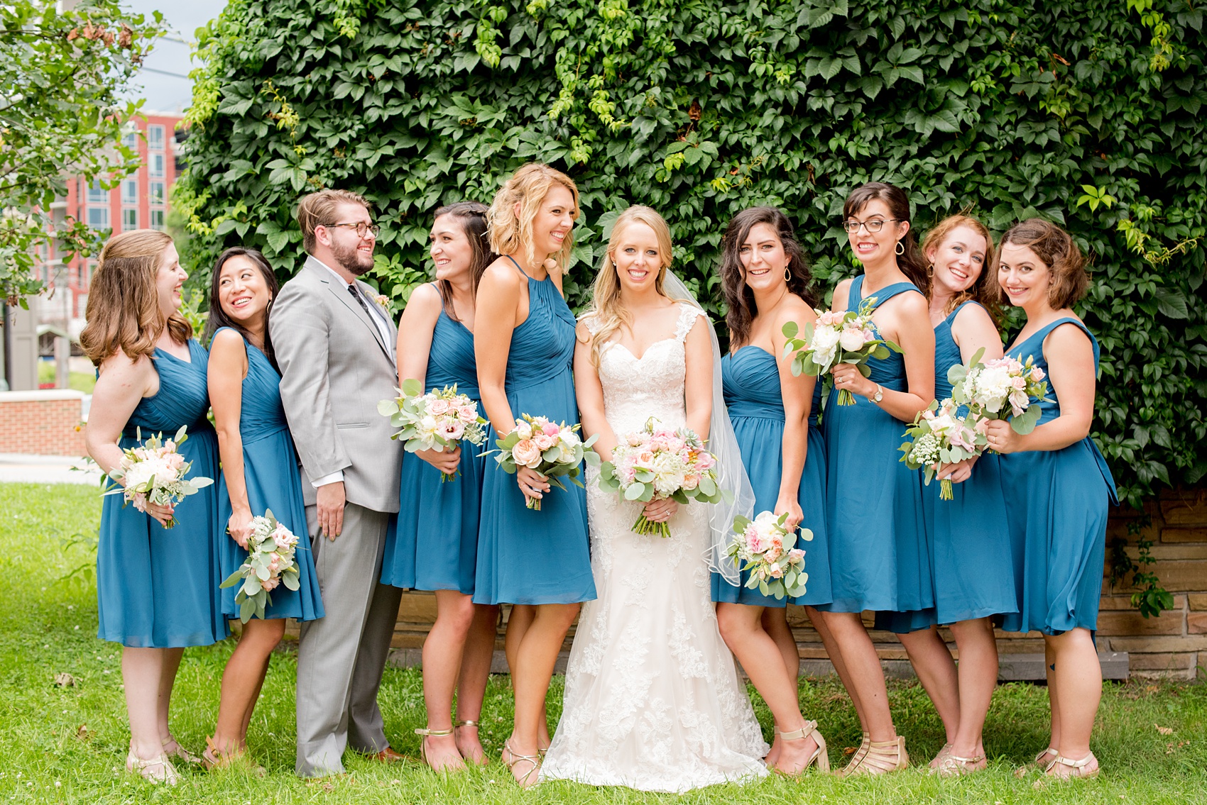 Mikkel Paige Photography photos from a wedding in Durham, North Carolina. Picture of the bridesmaids in teal dresses and a bridesdude in a grey suit.