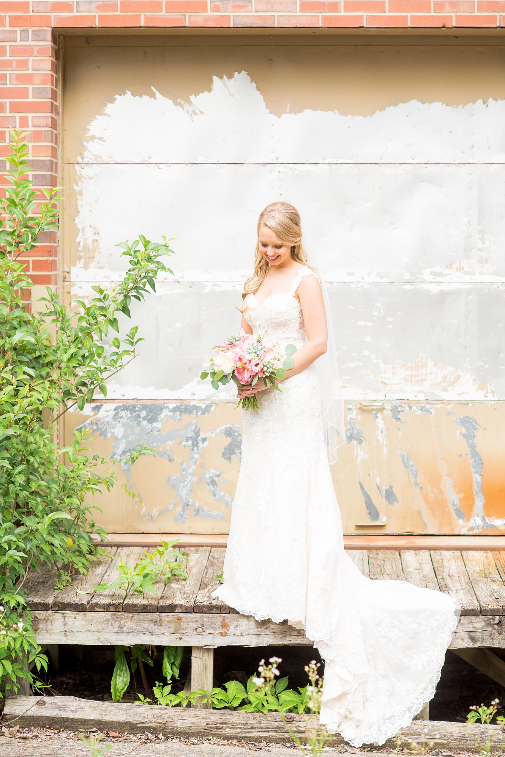 Mikkel Paige Photography photos from a wedding in Durham, North Carolina. Picture of the bride in an urban, rustic setting.