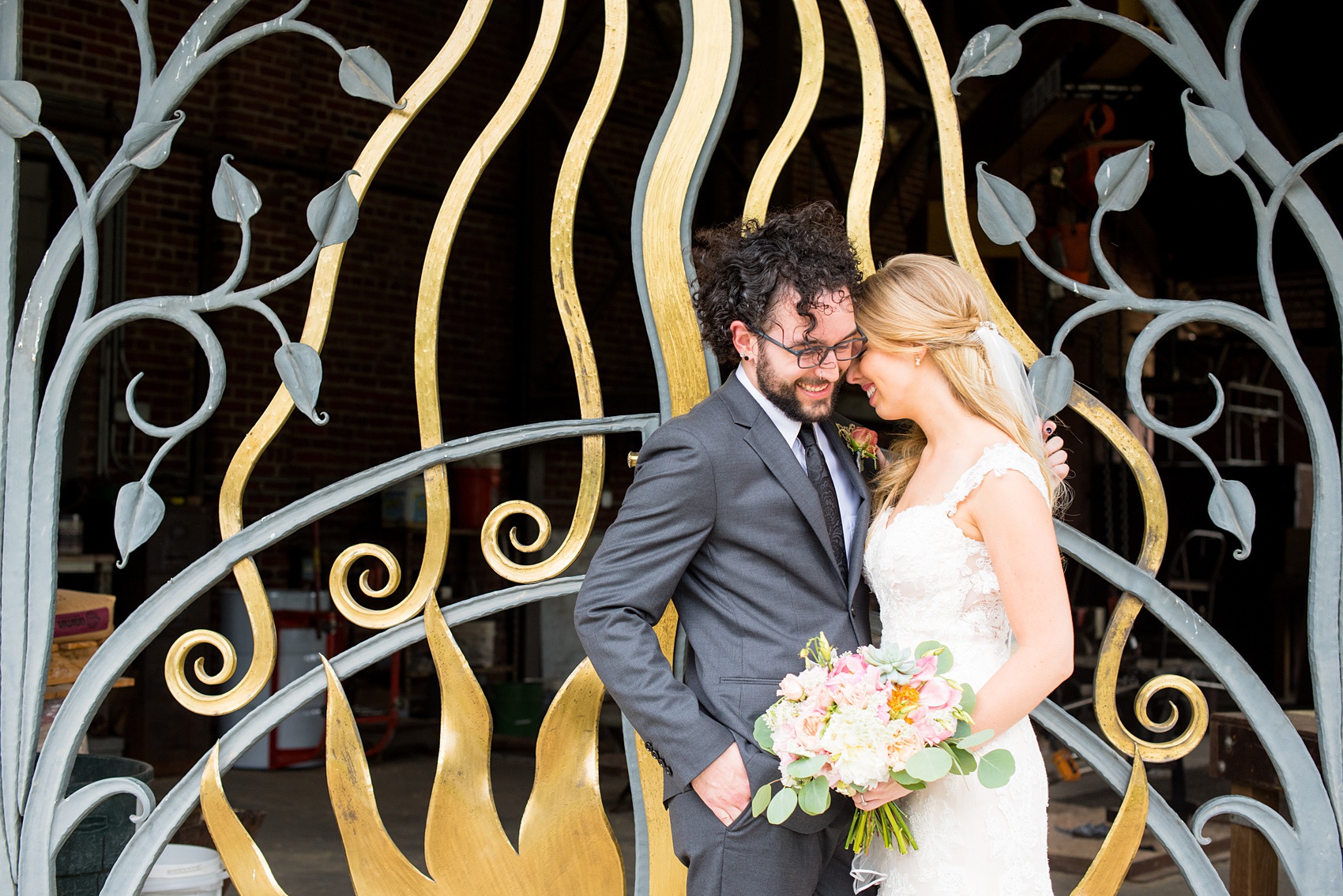 Mikkel Paige Photography photos from a wedding in Durham, North Carolina. Picture of the bride and groom in front of a black and gold gate.