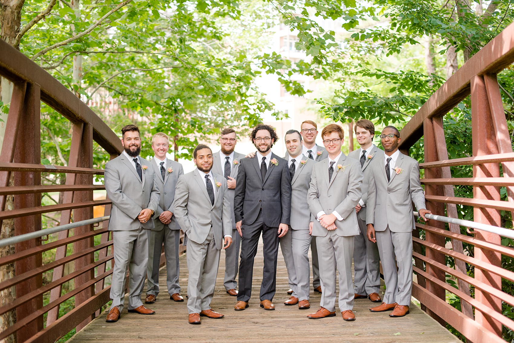 Mikkel Paige Photography photos from a wedding in Durham, North Carolina. Casual picture of the groomsmen on a rustic bridge downtown.