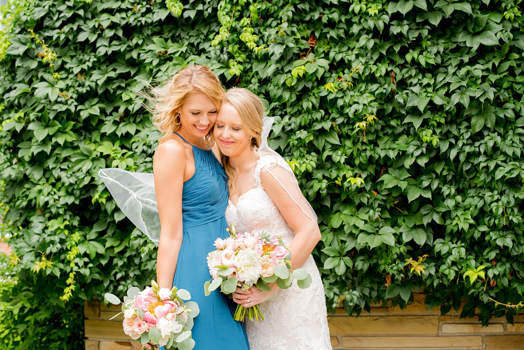 Mikkel Paige Photography photos from a wedding in Durham, North Carolina. Picture of the bride and her sister, Maid of Honor, in lace and teal.