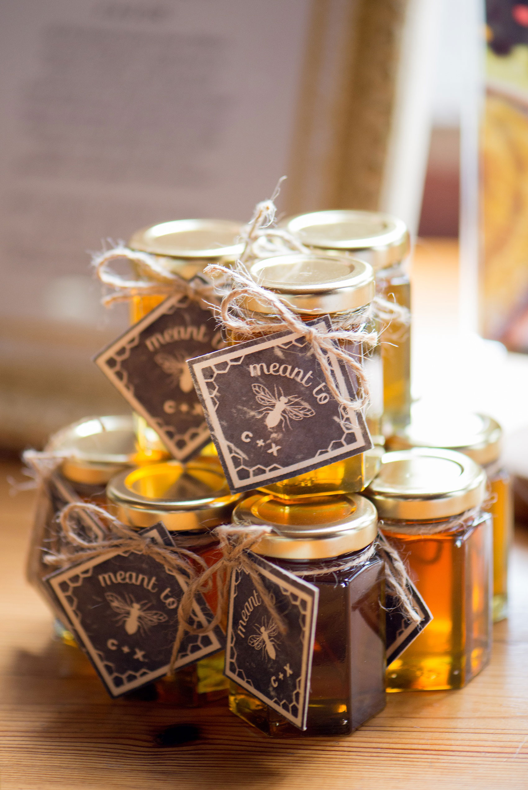 Mikkel Paige Photography photos from a wedding in Durham, North Carolina. Picture of the guest favors at The Rickhouse. Custom honey jars with bee's product from her father's farm and plantable tags.