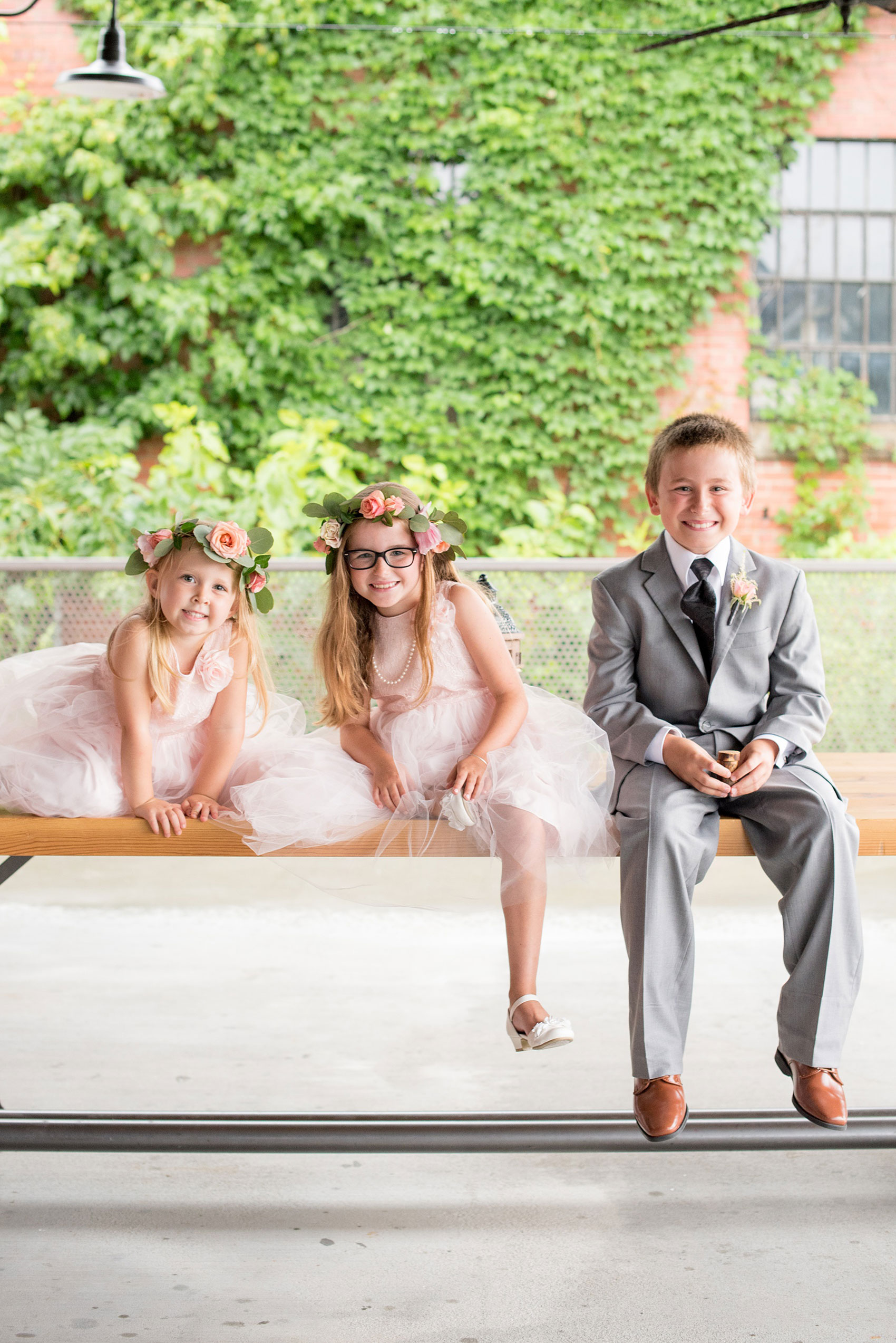 Mikkel Paige Photography photos from a wedding at The Rickhouse in Durham, North Carolina. Picture of the flower girls and ring bearer before the ceremony.