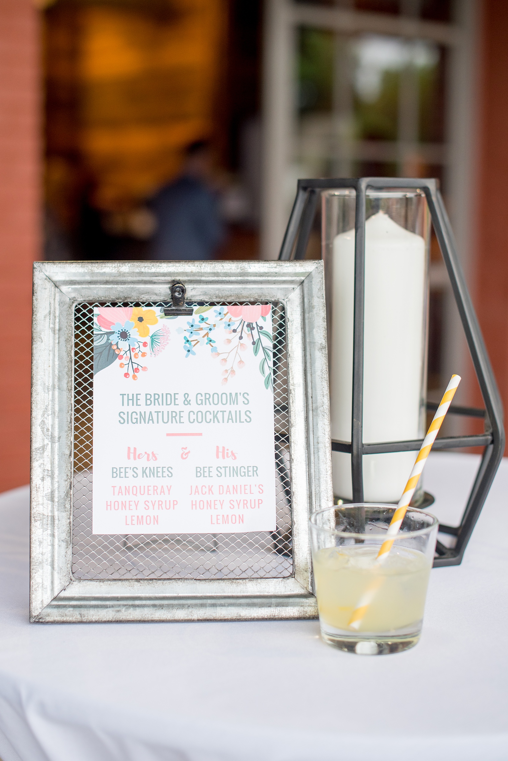 Mikkel Paige Photography photos from a wedding at The Rickhouse in Durham, North Carolina. Picture of the signature drink sign during cocktail hour on the outdoor deck.