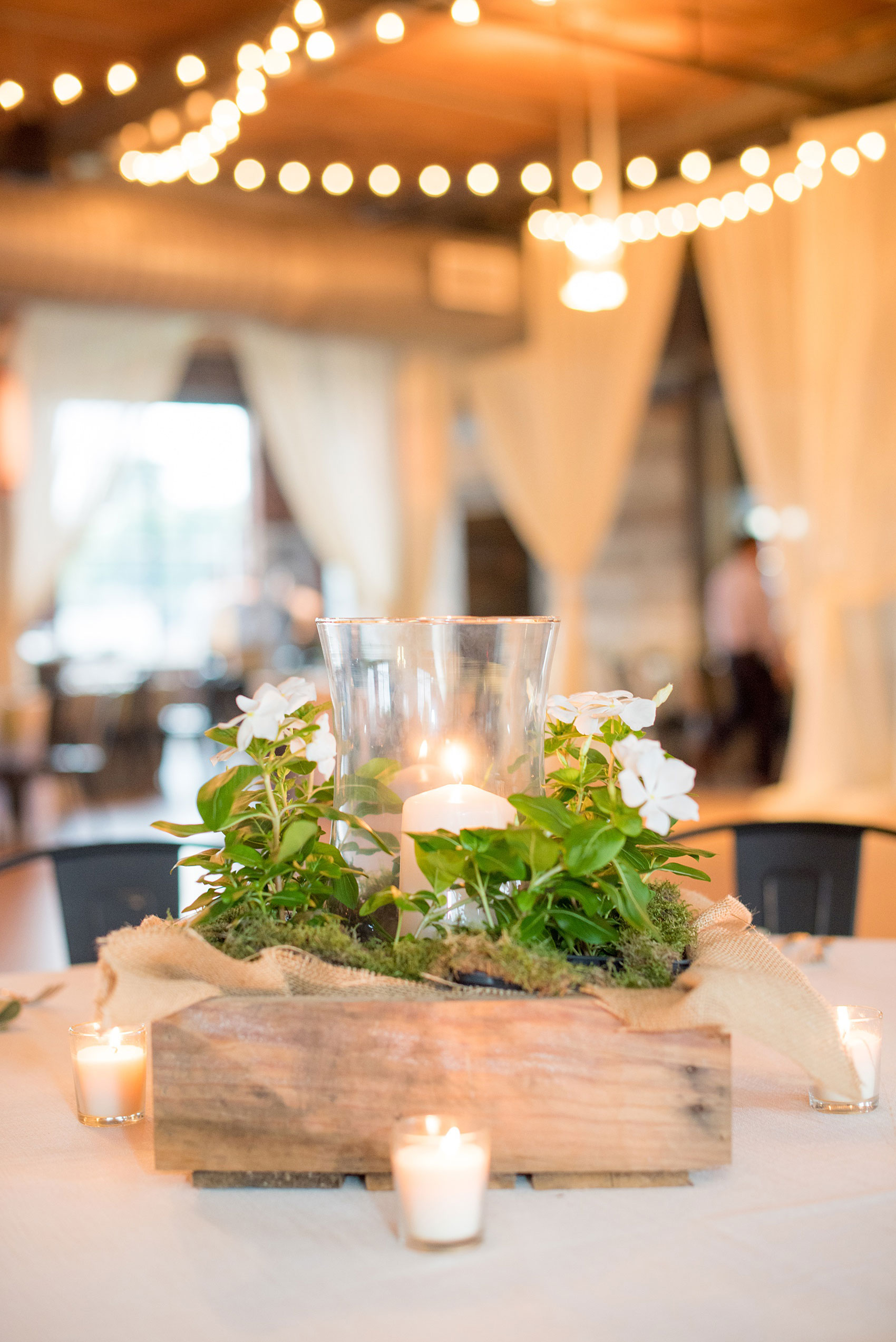 Mikkel Paige Photography photos from a wedding at The Rickhouse in Durham, North Carolina. Picture of the reception setup with flowers and rustic lantern centerpieces.