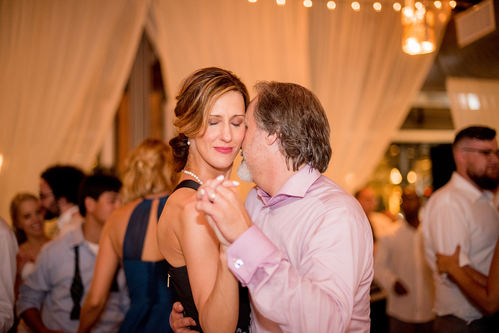 Mikkel Paige Photography photos from a wedding at The Rickhouse in Durham, North Carolina. Picture of two wedding guests dancing.