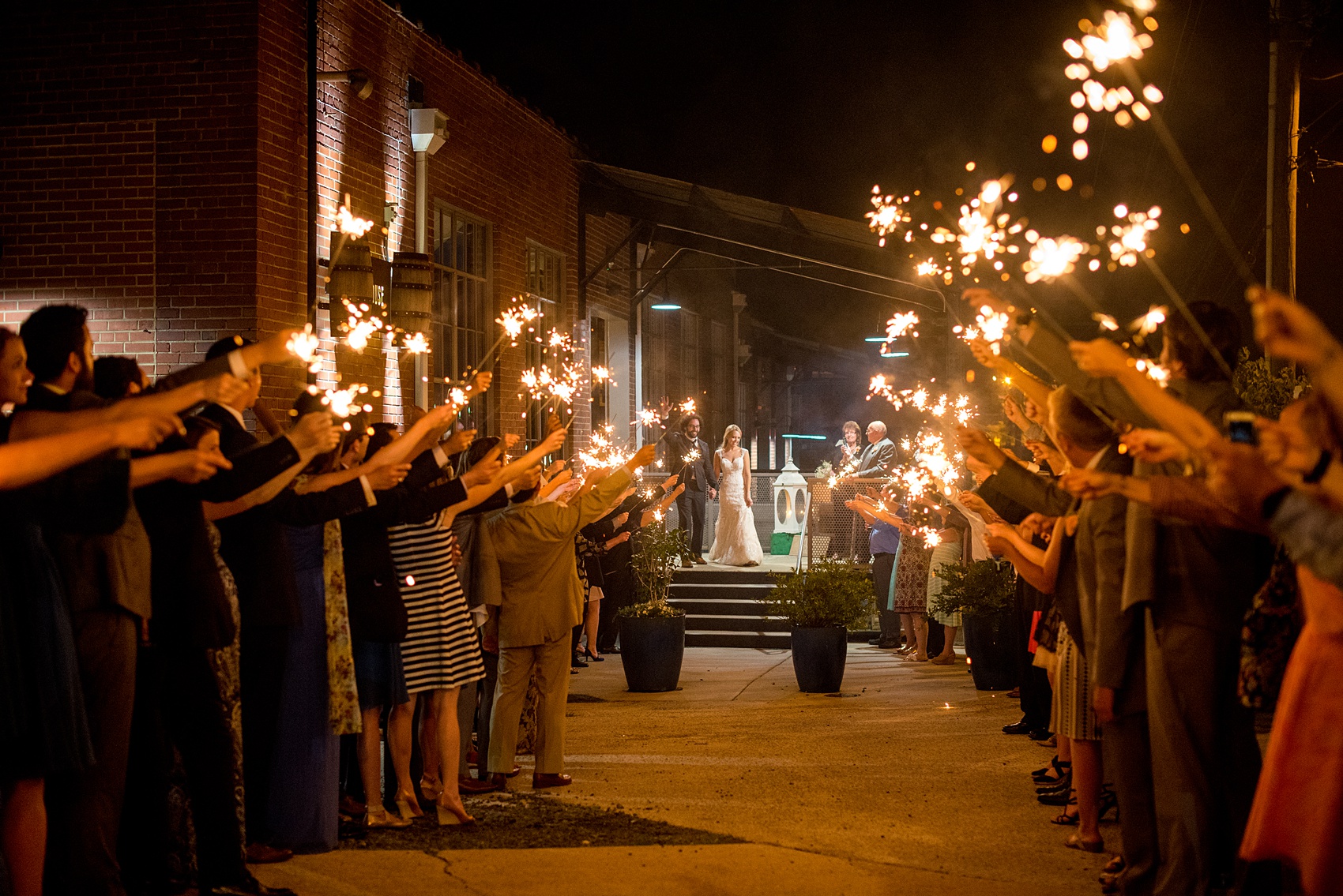 Mikkel Paige Photography photos from a wedding at The Rickhouse in Durham, North Carolina. Picture of the couple's sparkler exit.