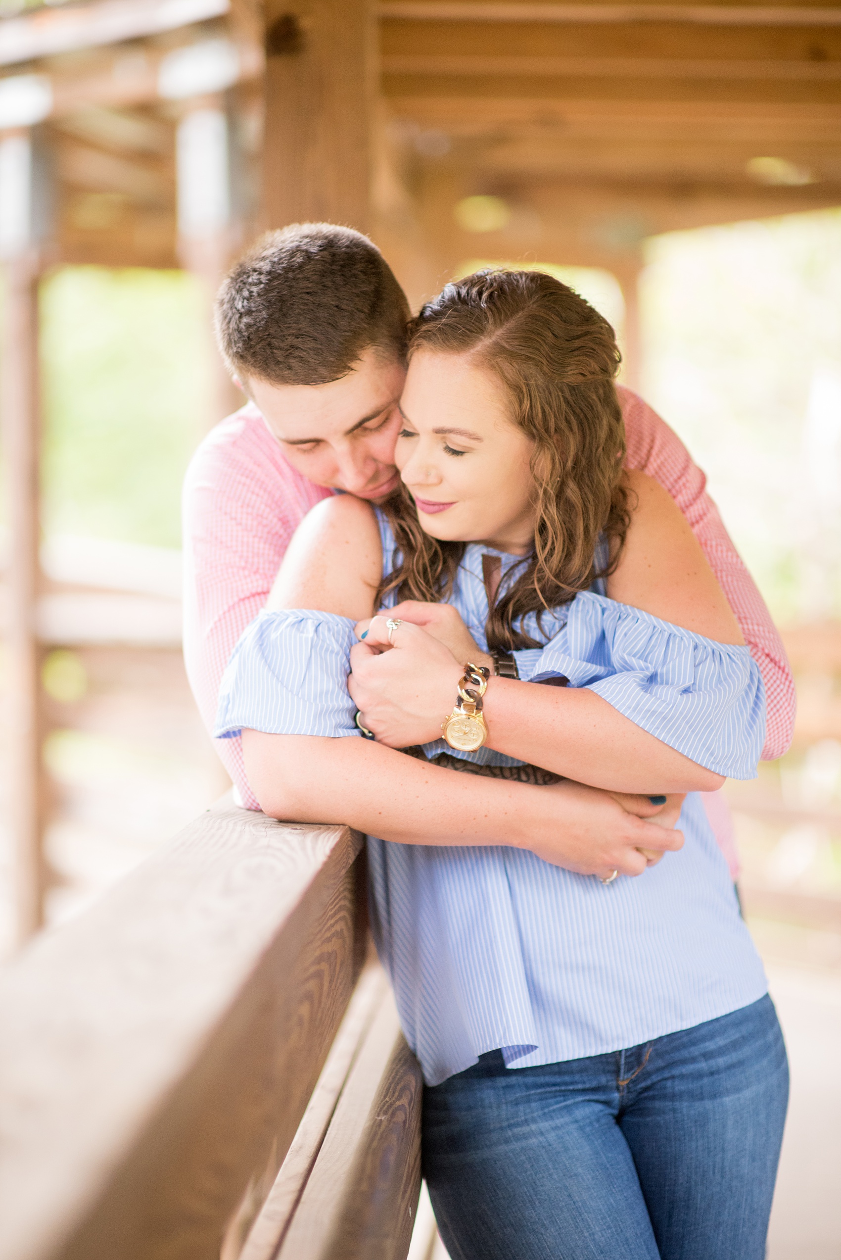 Mikkel Paige Photography photos of an engagement session at Eno Riverwalk in Hillsborough, North Carolina. Picture of the groom and bride hugging.