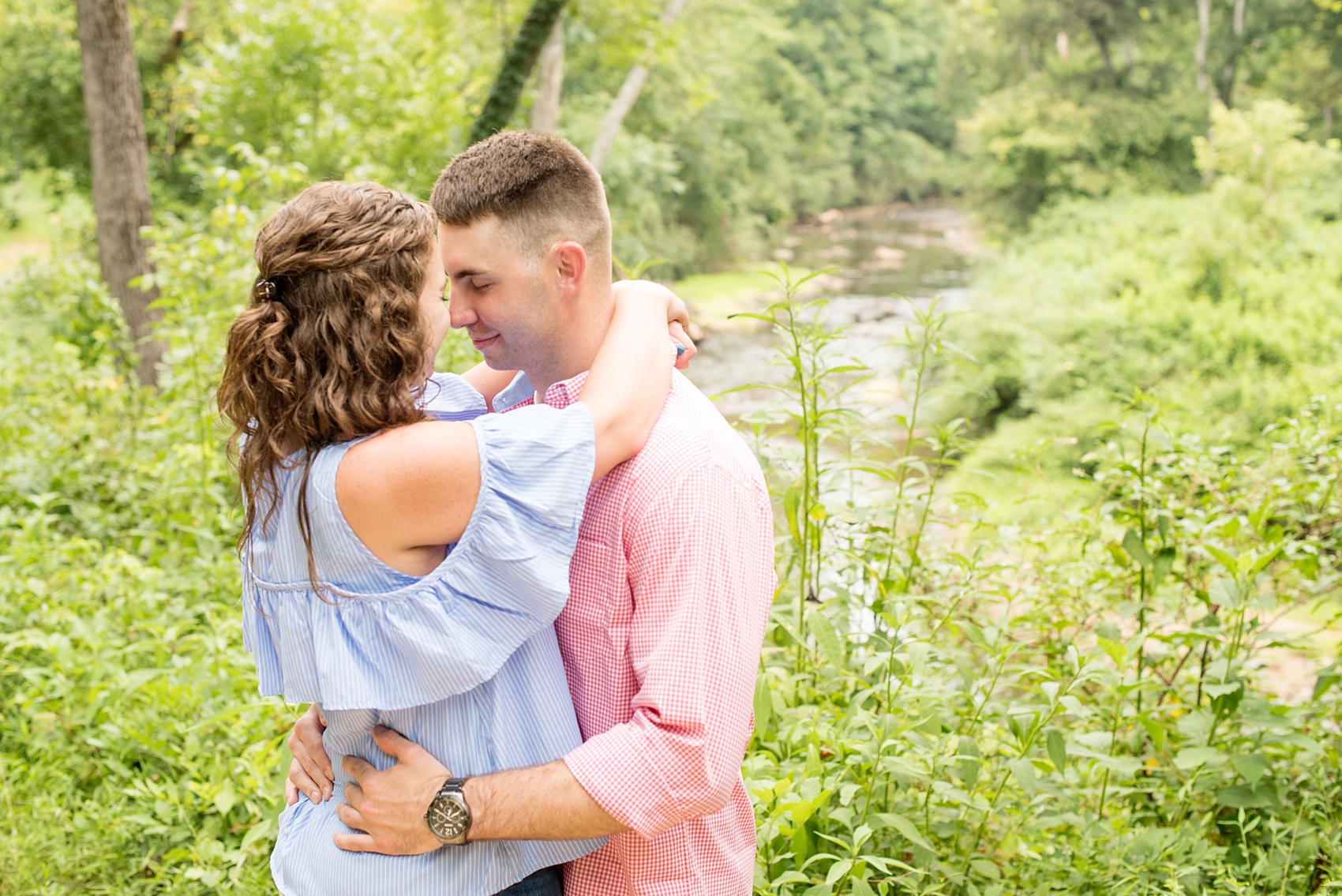 Mikkel Paige Photography photos of an engagement session at Eno Riverwalk in Hillsborough, North Carolina. Picture of the bride and groom with a river in the background.