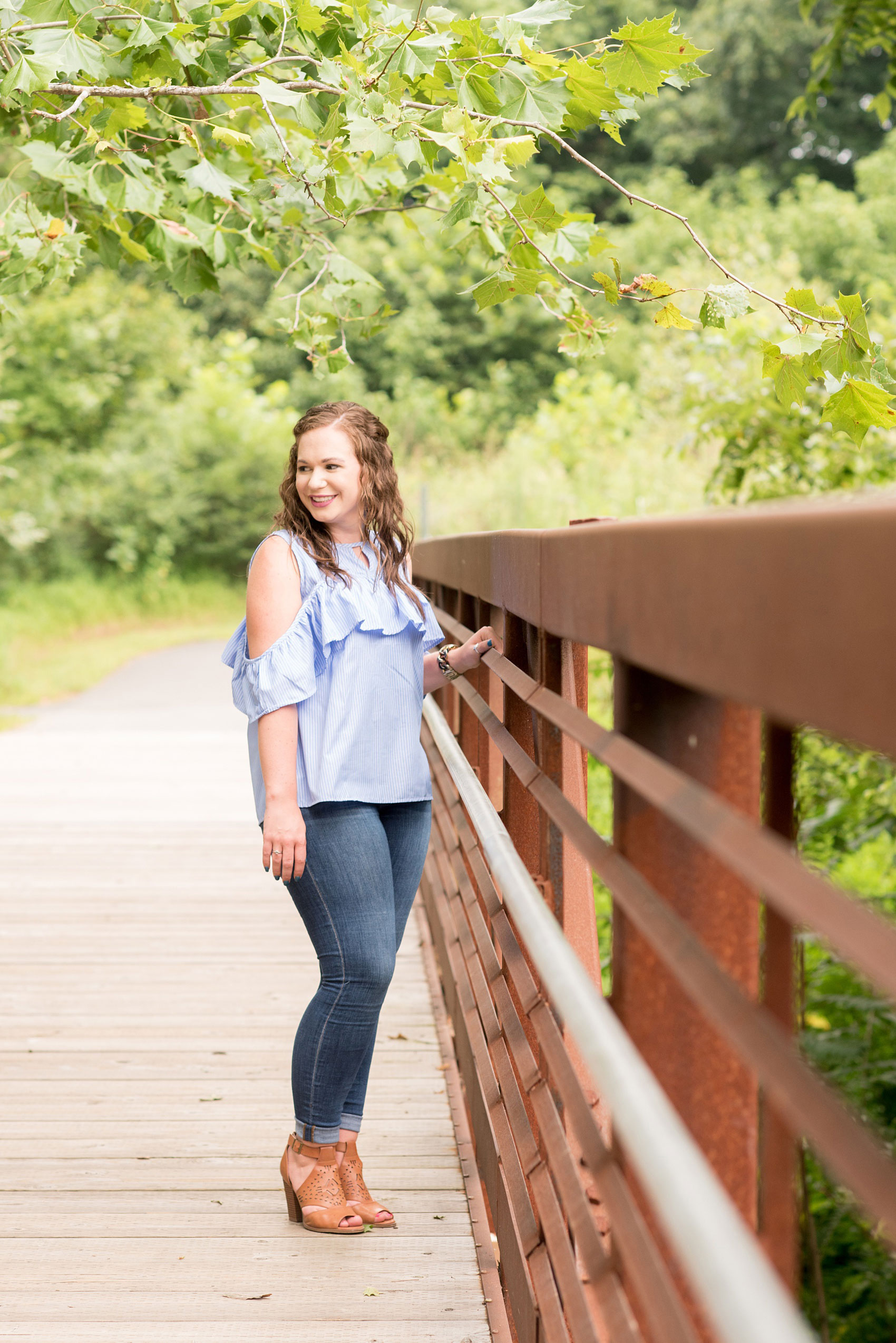 Mikkel Paige Photography photos of an engagement session at Eno Riverwalk in Hillsborough, North Carolina. Picture of the bride on a rustic bridge.