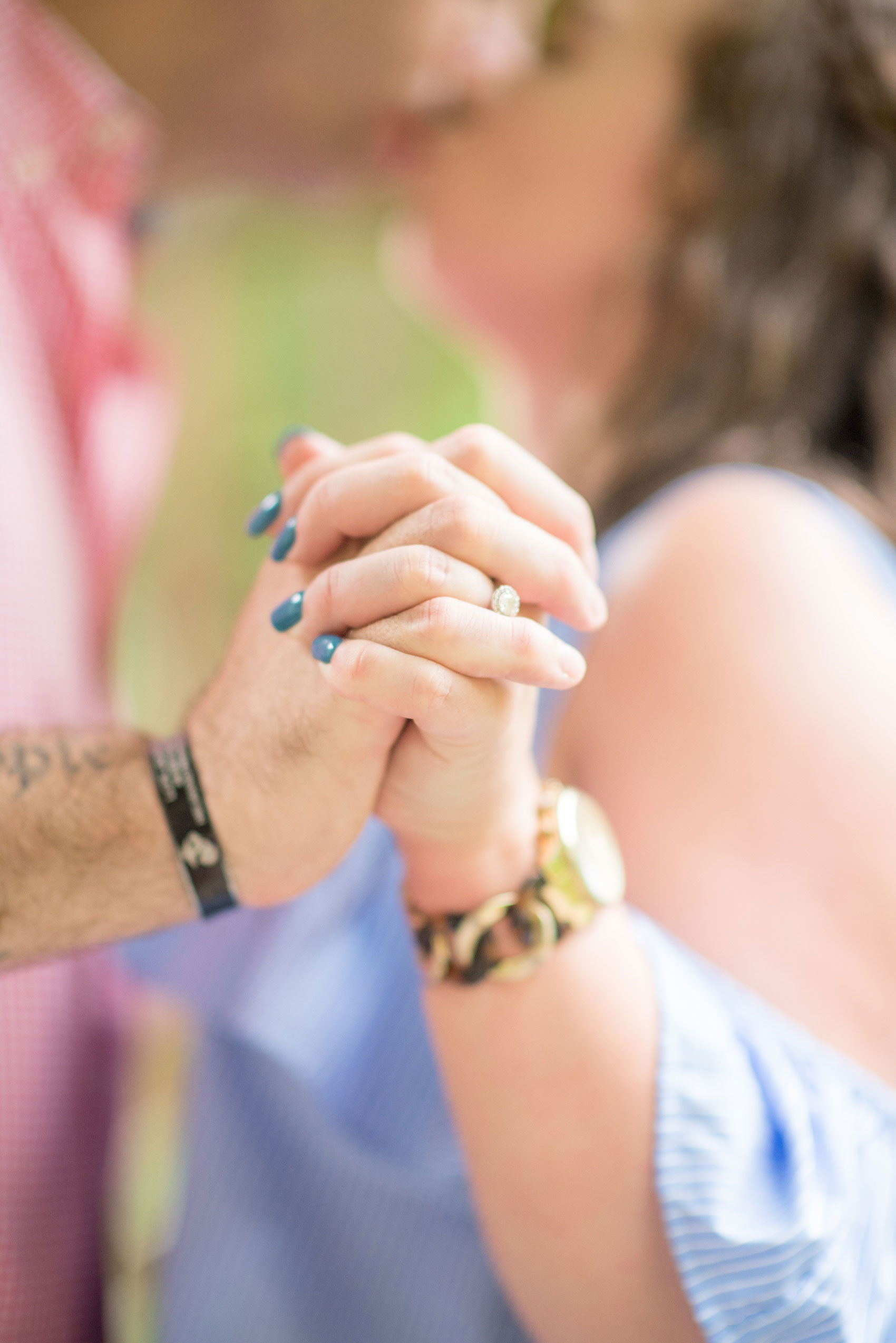 Mikkel Paige Photography photos of an engagement session at Eno Riverwalk in Hillsborough, North Carolina. Picture of bride and groom's interlocked hands.