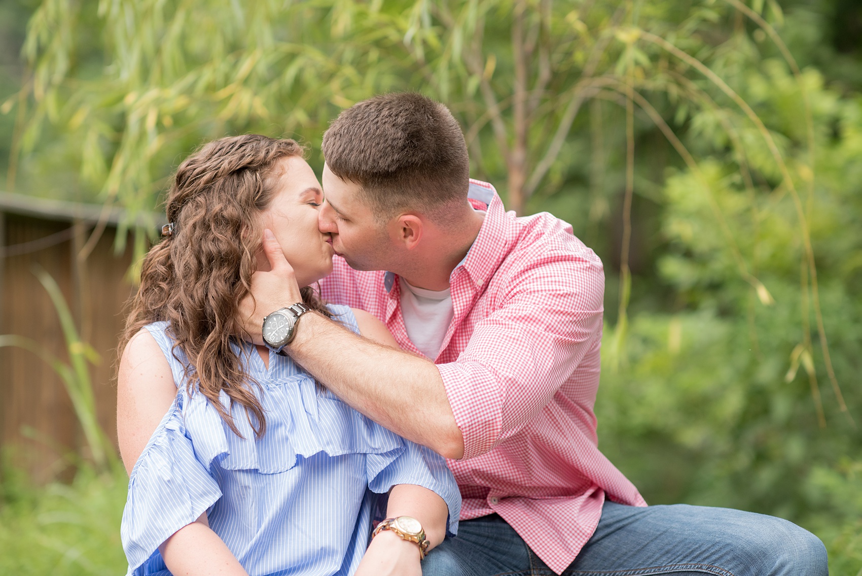 Mikkel Paige Photography photos of an engagement session at Eno Riverwalk in Hillsborough, North Carolina. Photo of the groom kissing the bride.