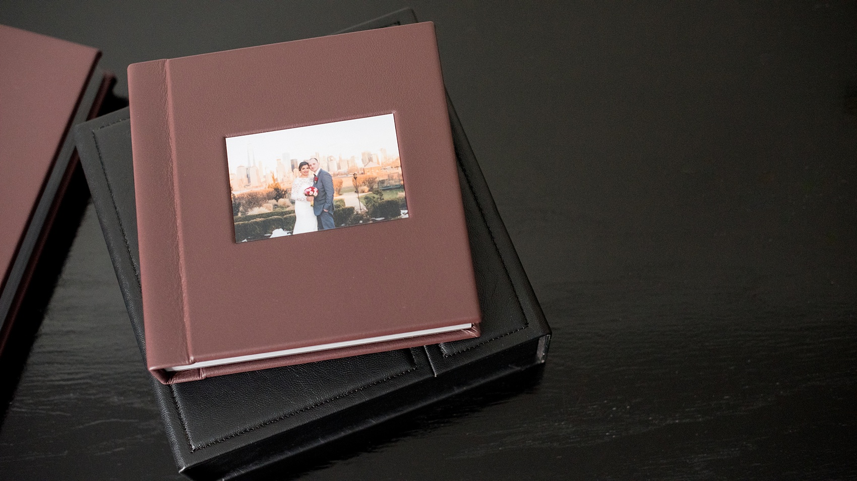 Mikkel Paige Photography photos of a fine art leather Madera wedding album in Oxblood. Album for the bride and groom with inset cover photo and debossing.