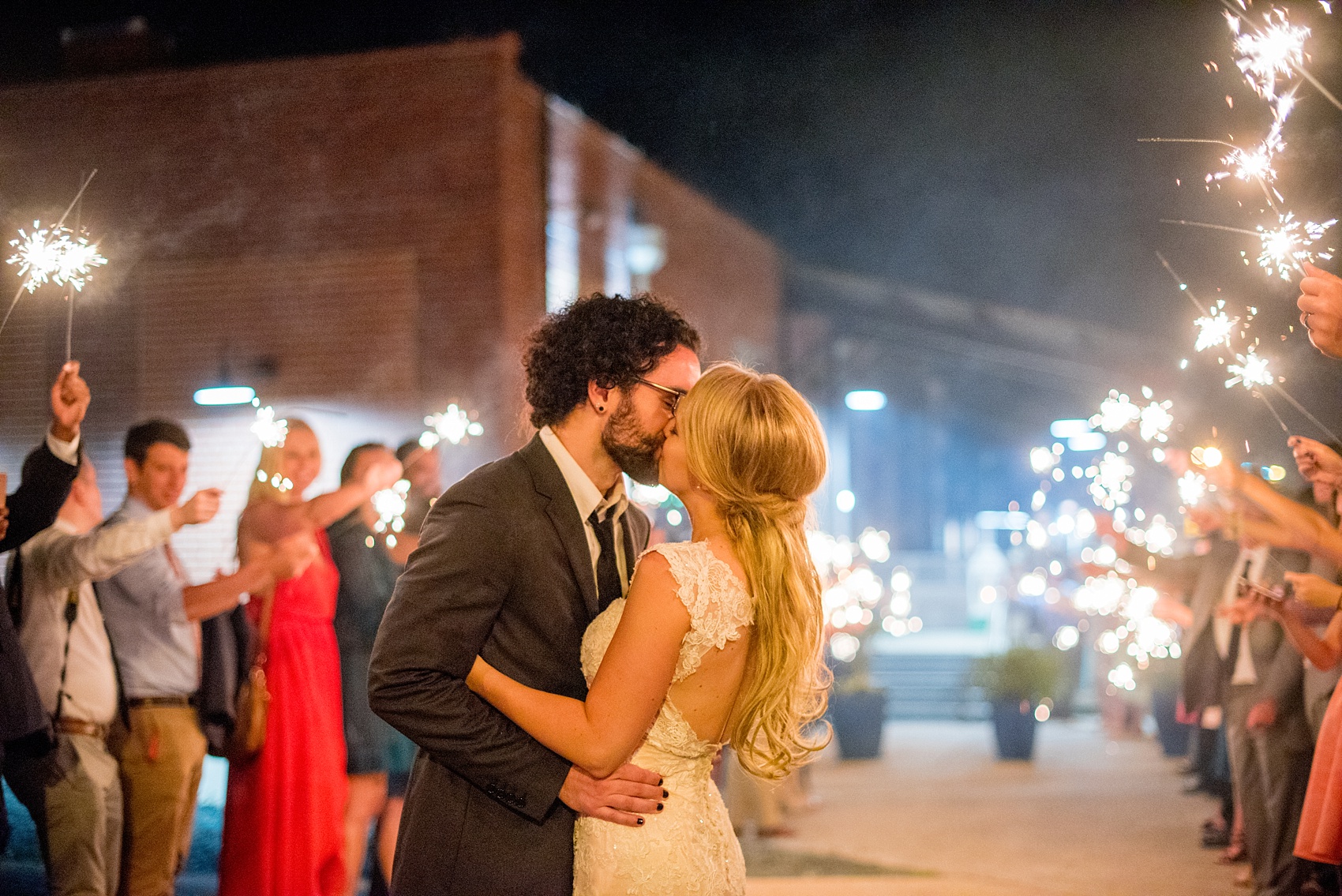 Mikkel Paige Photography photos from a wedding at The Rickhouse in Durham, North Carolina. Picture of the couple's sparkler exit.