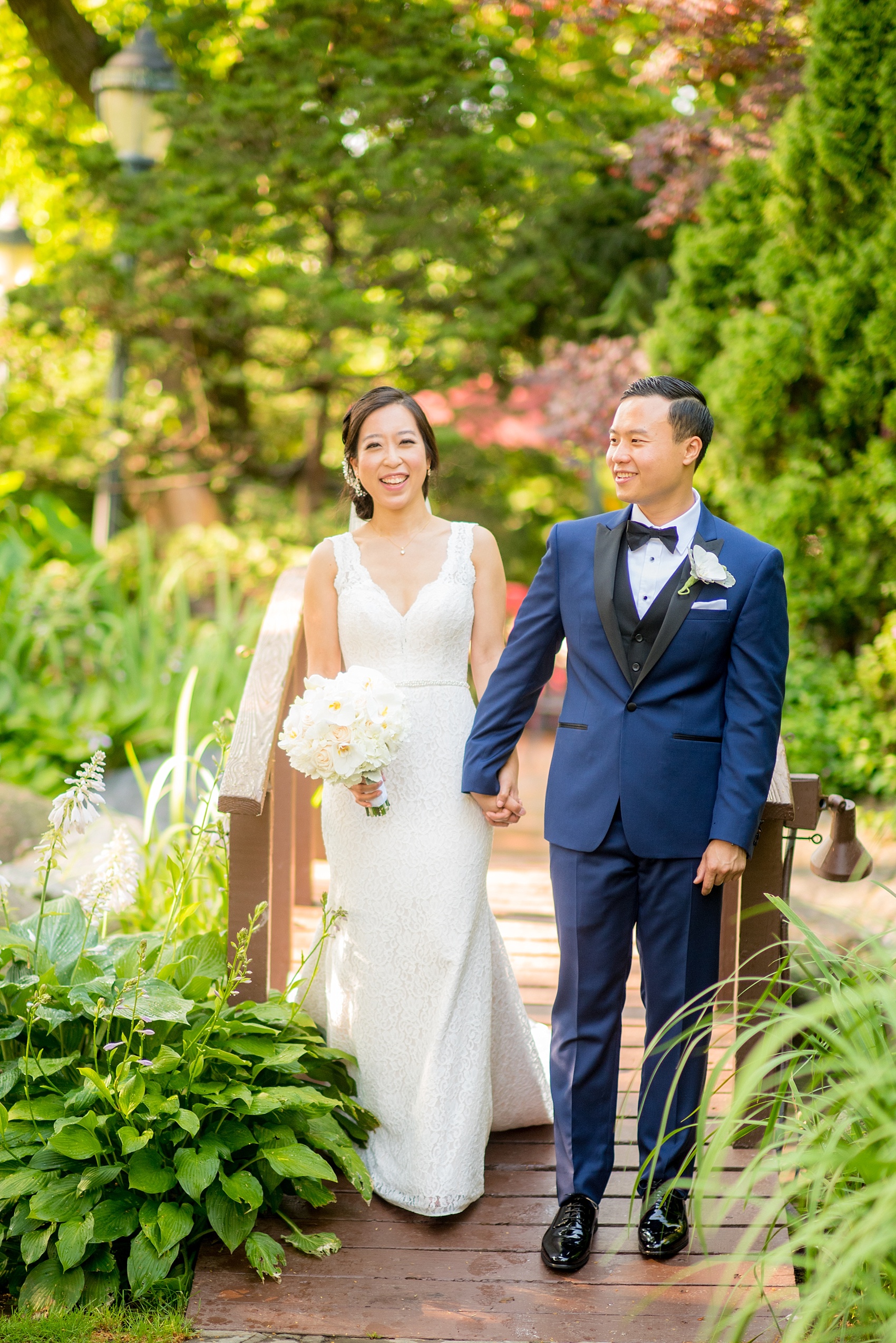 Westbury Manor wedding photos by Mikkel Paige photography. Bride in a lace Mikaella gown and groom in a navy blue and black tuxedo for a Long Island summer celebration.