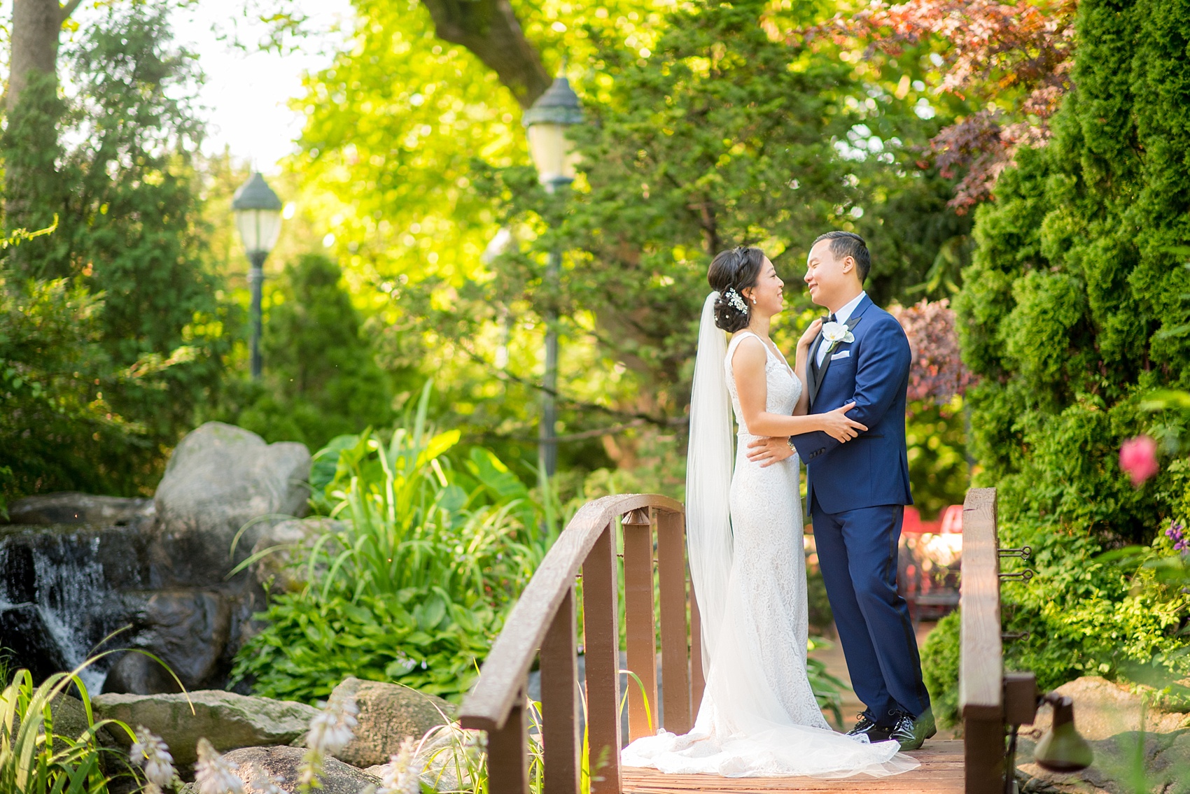 Westbury Manor wedding photos by Mikkel Paige photography. Bride in a lace Mikaella gown and groom in a navy blue and black tuxedo for a Long Island summer celebration.