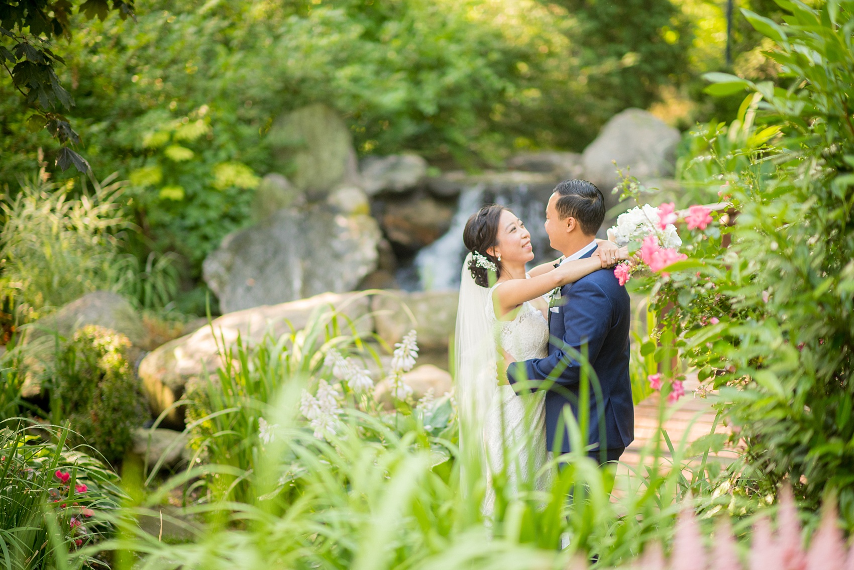 Westbury Manor wedding photos by Mikkel Paige photography. Bride in a lace Mikaella gown and groom in a navy blue and black tuxedo for a Long Island summer celebration.