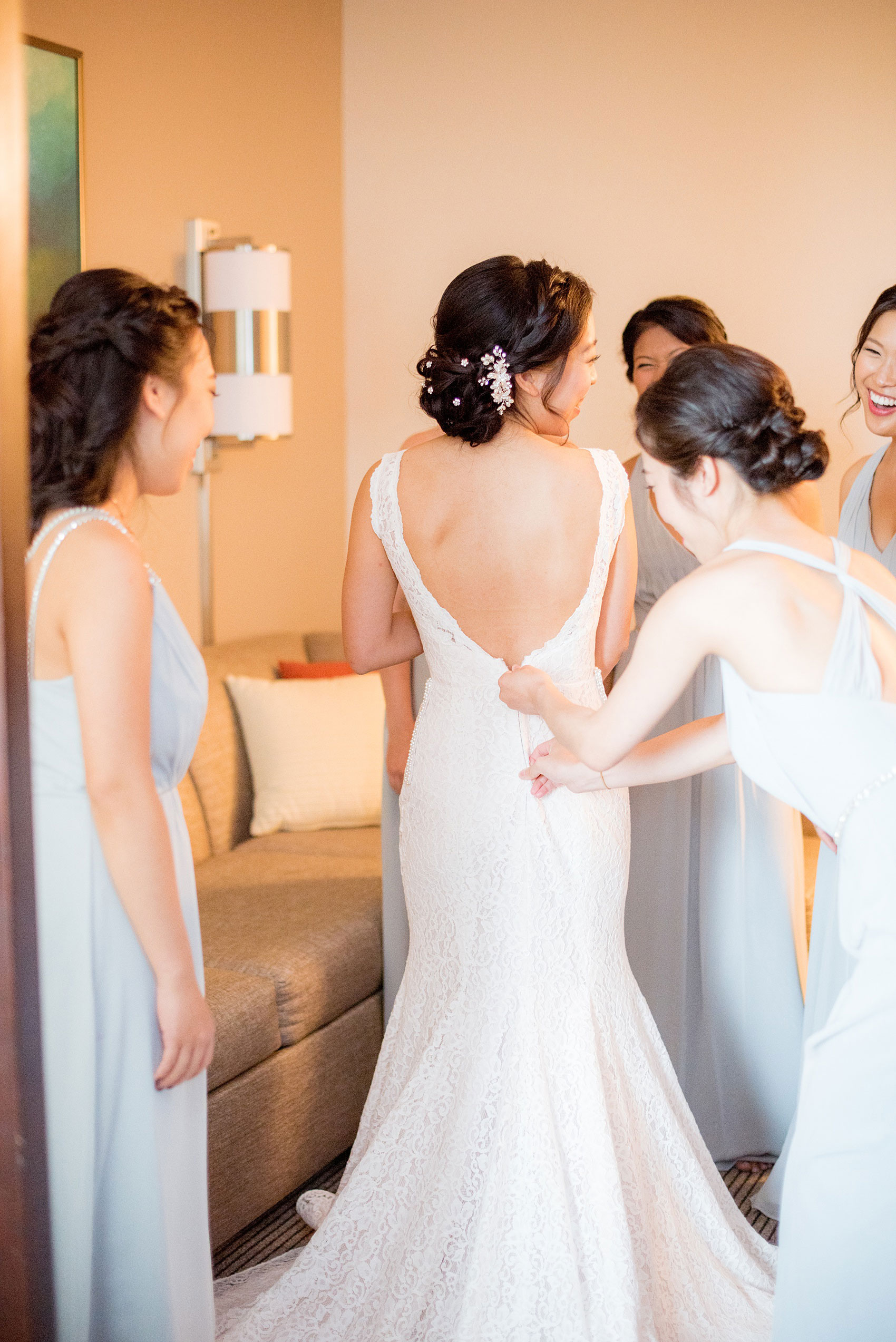 Mikkel Paige Photography pictures of a Westbury Manor wedding on Long Island. Detail photo of the bride getting into her lace Mikaella Bridal wedding gown.