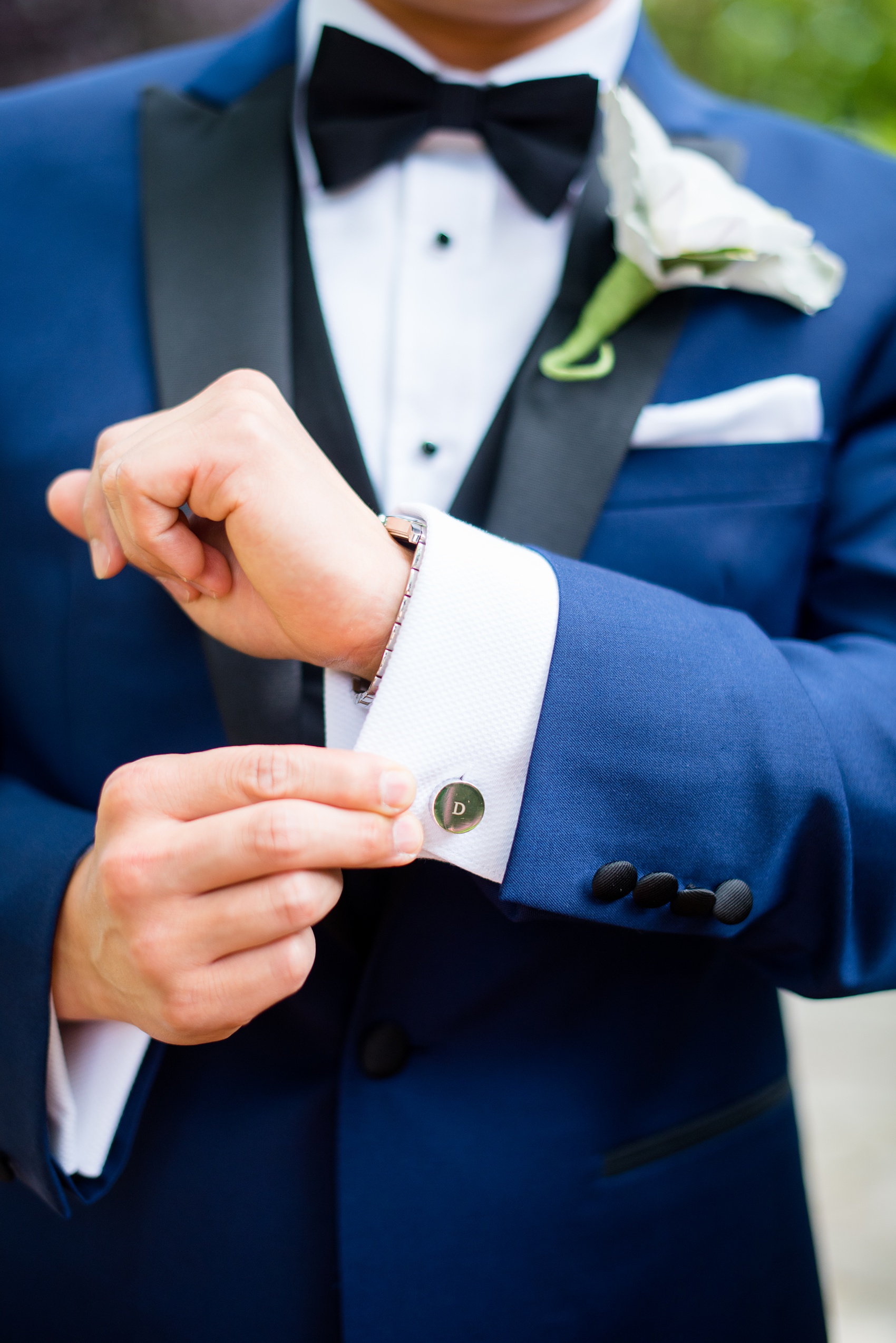 Mikkel Paige Photography pictures of a Westbury Manor wedding on Long Island. Detail photo the groom's custom monogram cufflinks and blue suit.