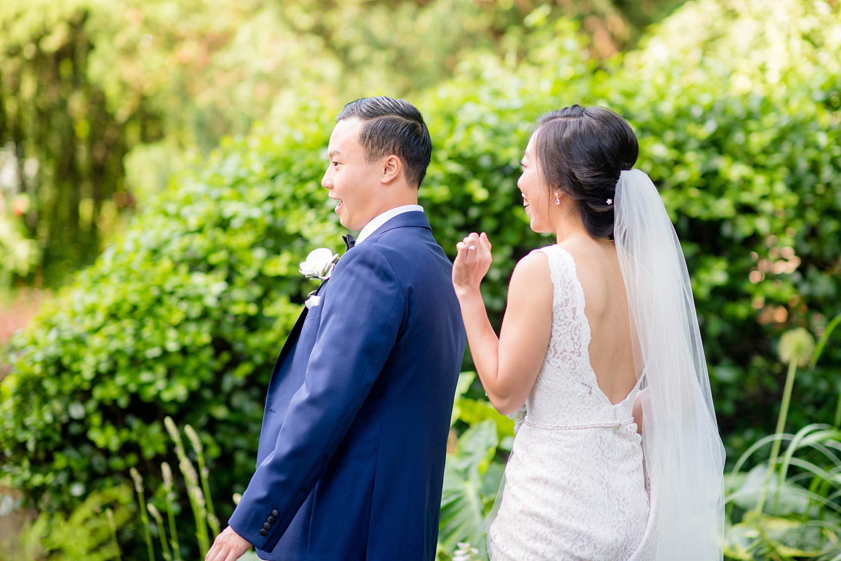 Mikkel Paige Photography pictures of a Westbury Manor wedding on Long Island. Photo of the bride and groom's first look in the gardens.