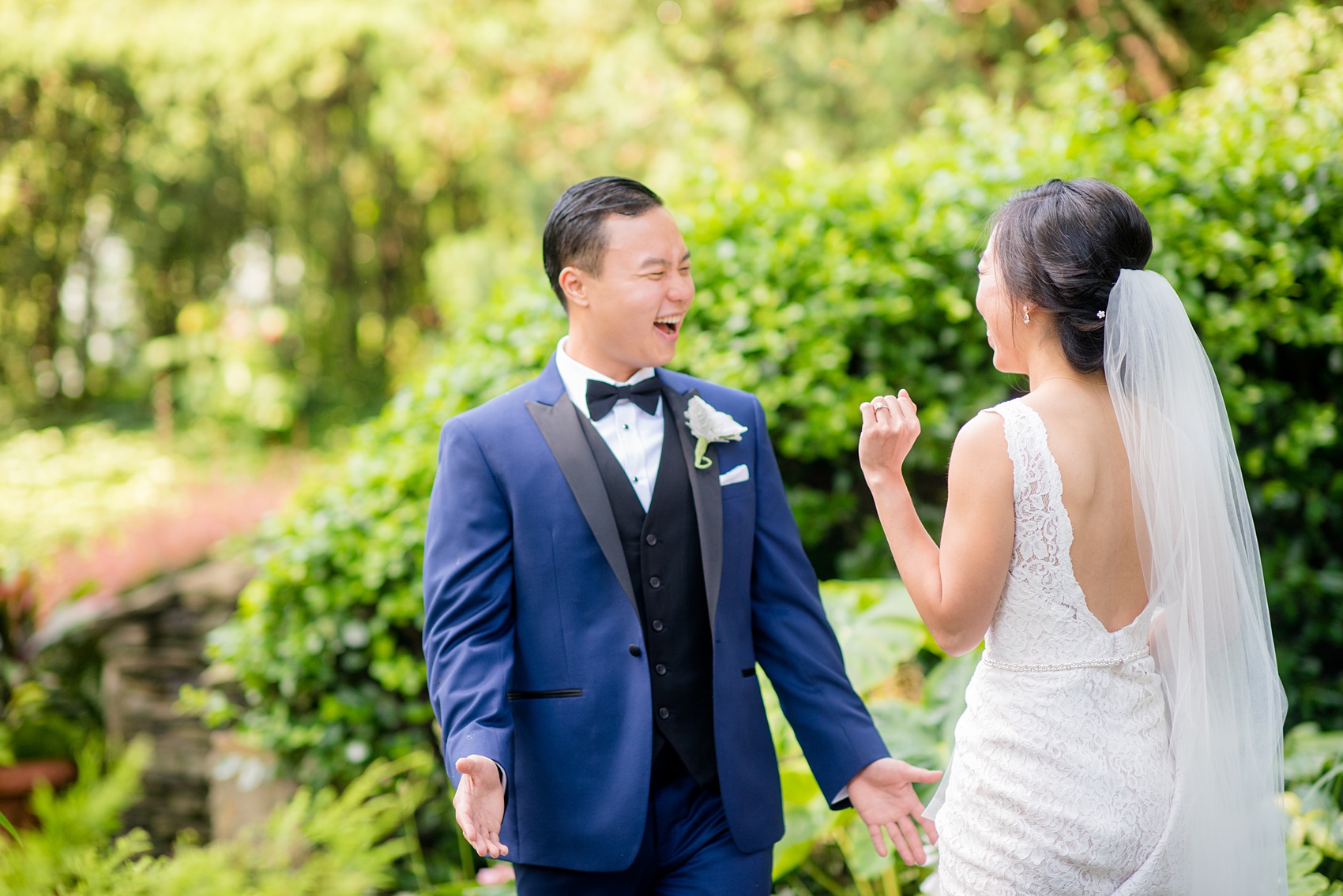 Mikkel Paige Photography pictures of a Westbury Manor wedding on Long Island. Photo of the bride and groom's first look in the gardens.