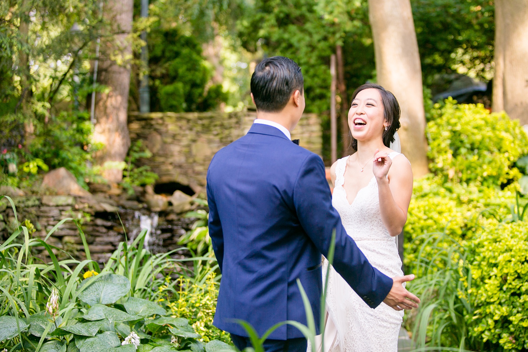 Mikkel Paige Photography pictures of a Westbury Manor wedding on Long Island. Photo of the bride and groom's first look in the gardens.